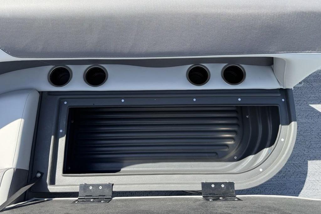 2026 Sun Tracker Bass Buggy 18 DLX interior storage compartment with cup holders.