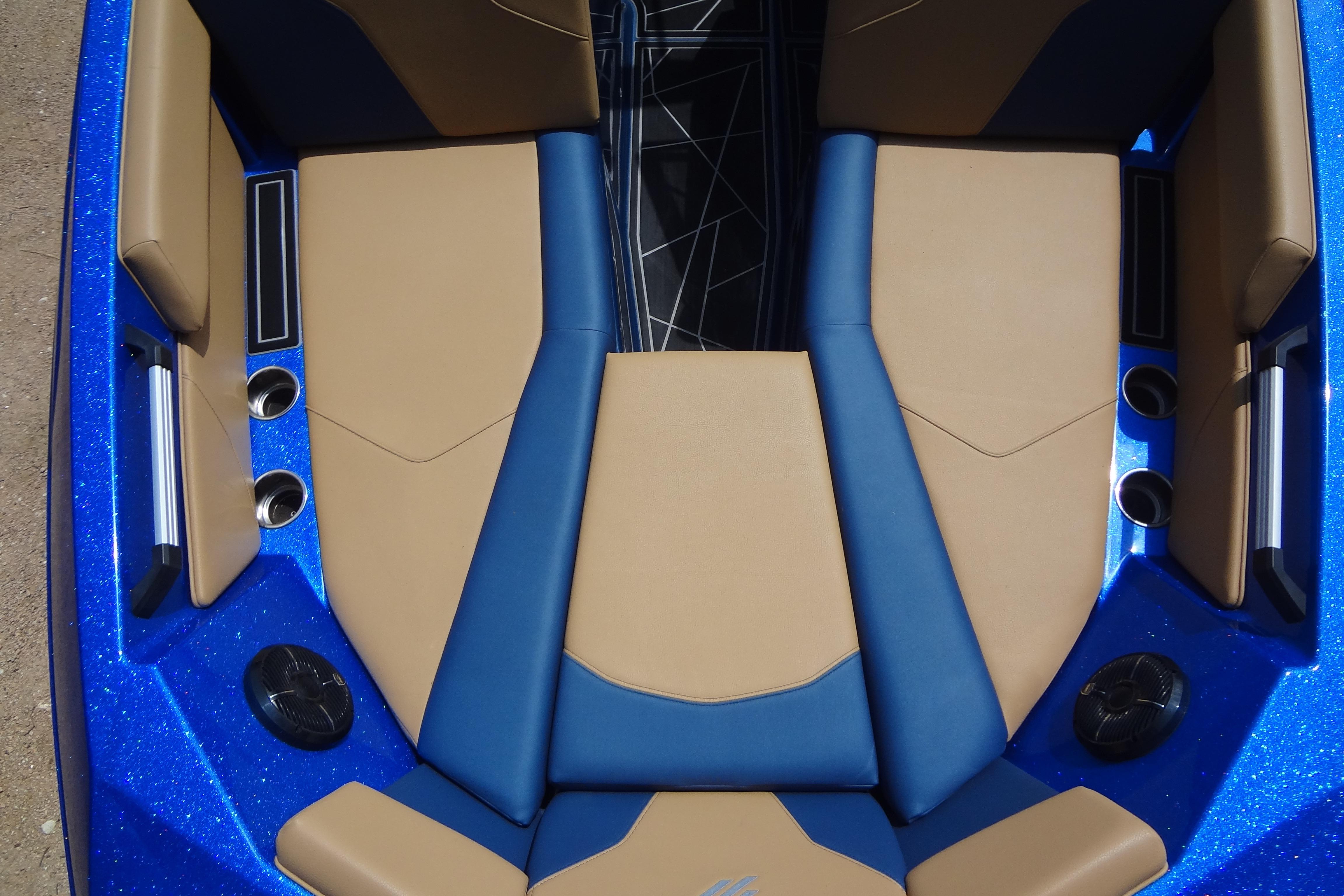 2022 ATX Surf Boats 24 Type-S interior with tan and blue seating, cup holders, and speakers.