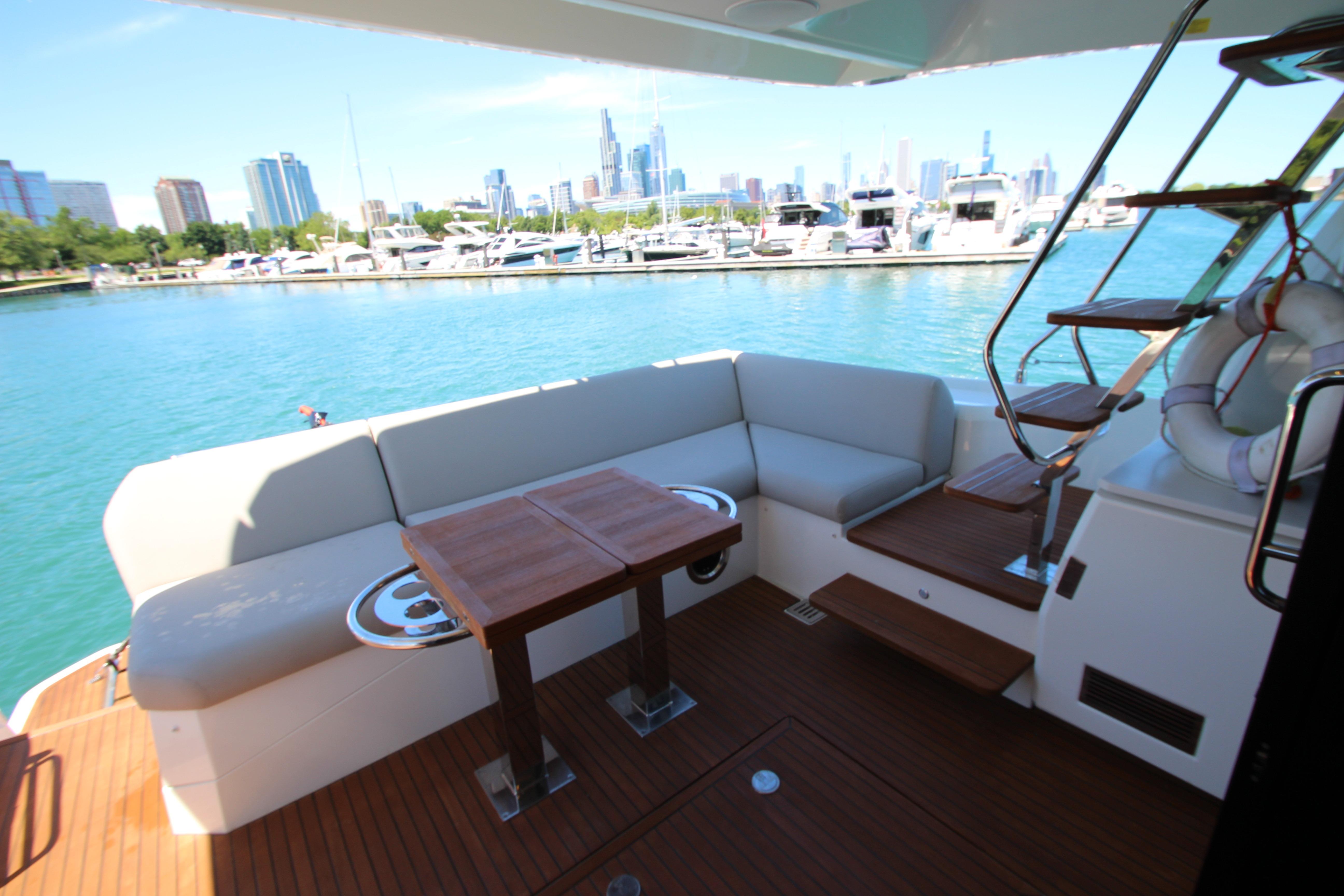 Luxury 2022 Prestige 520 yacht with elegant seating and scenic marina view.