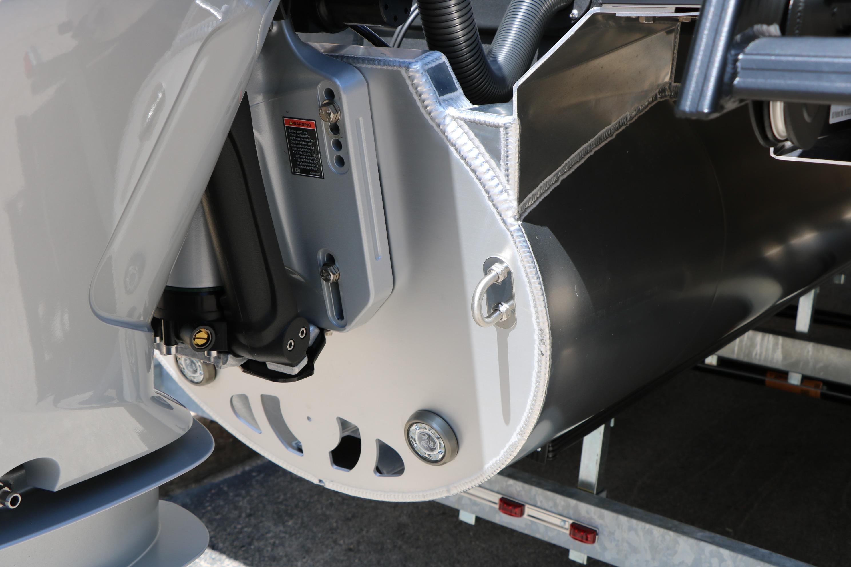 Close-up of 2026 Evotti 725 CS Tri-Toon boat's engine and pontoon details.