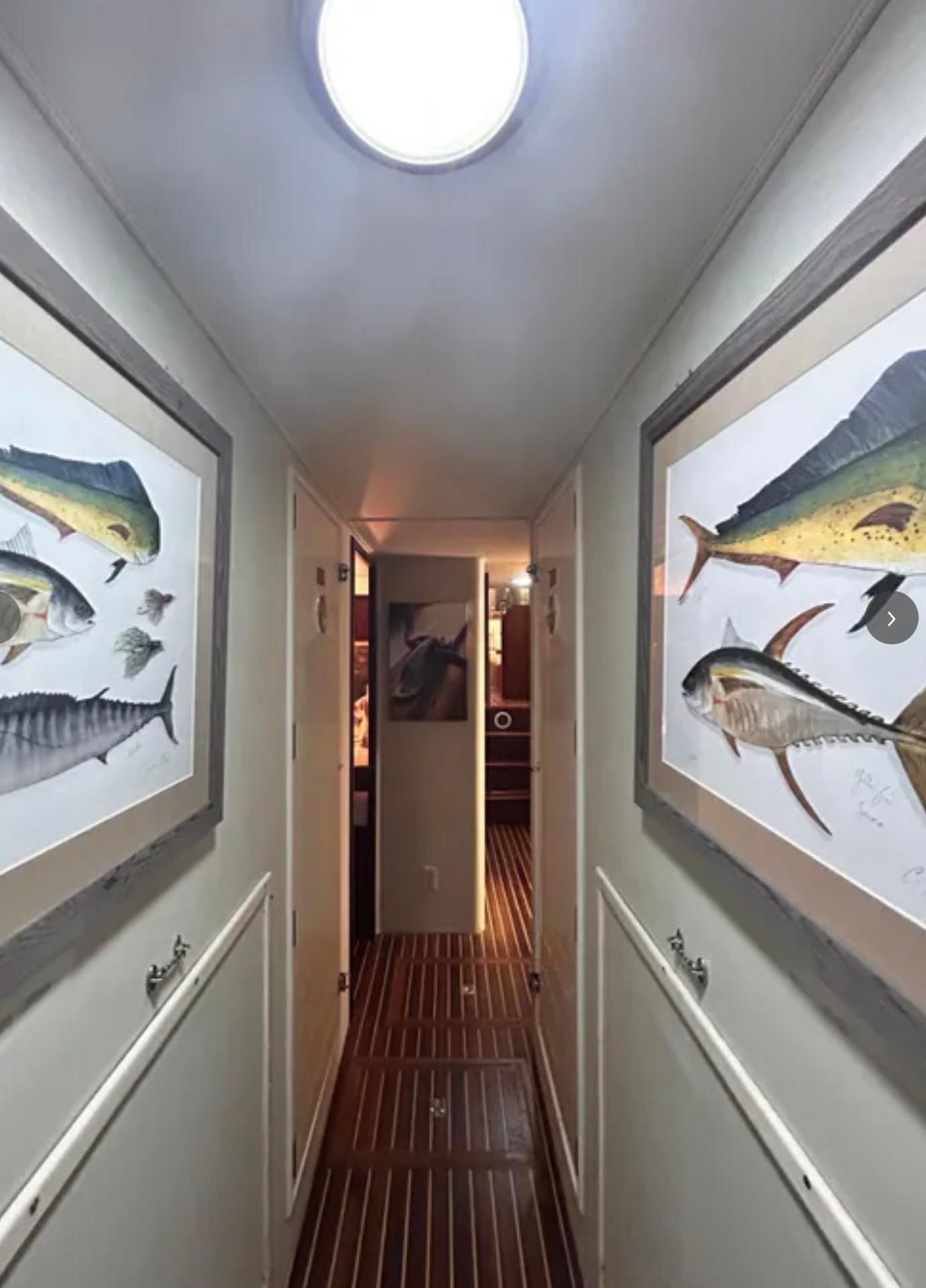 Hallway of 1989 Hatteras 67 Cockpit Motor Yacht with fish artwork.