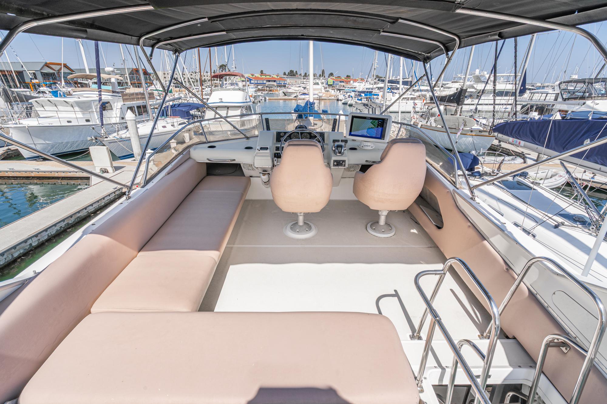 Flybridge of 1992 Bayliner 4388 yacht with seating and helm, docked in marina.