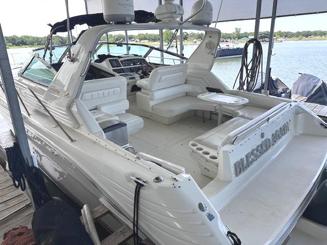 1995 Sea Ray 400 Express Cruiser docked, featuring spacious seating and sleek design.