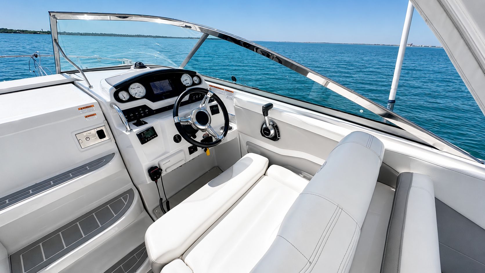 The cockpit of a 2020 Regal 28 Express with white seating and controls.