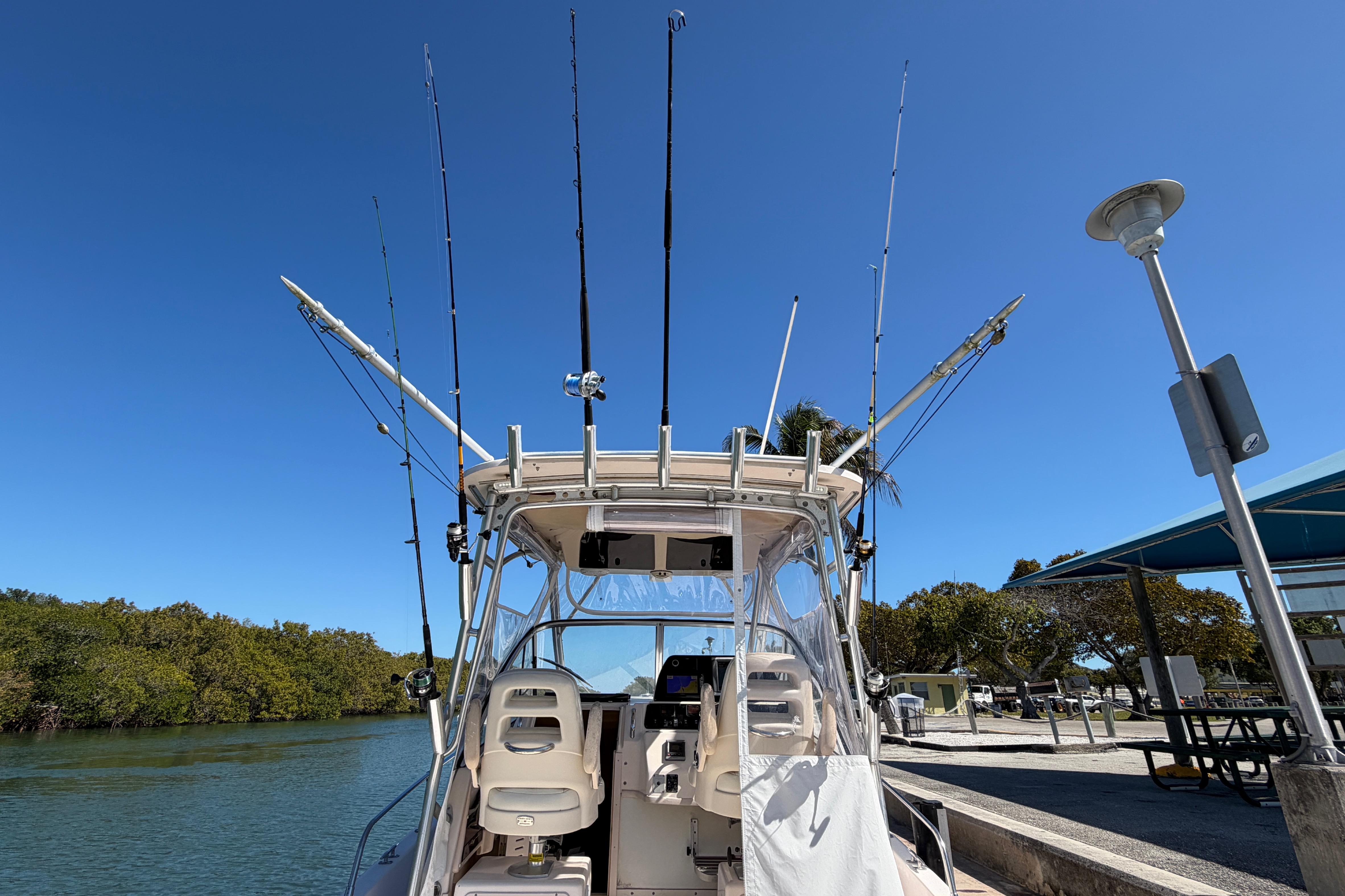 2006 Grady-White Sailfish 282 boat with fishing rods docked under clear blue sky.