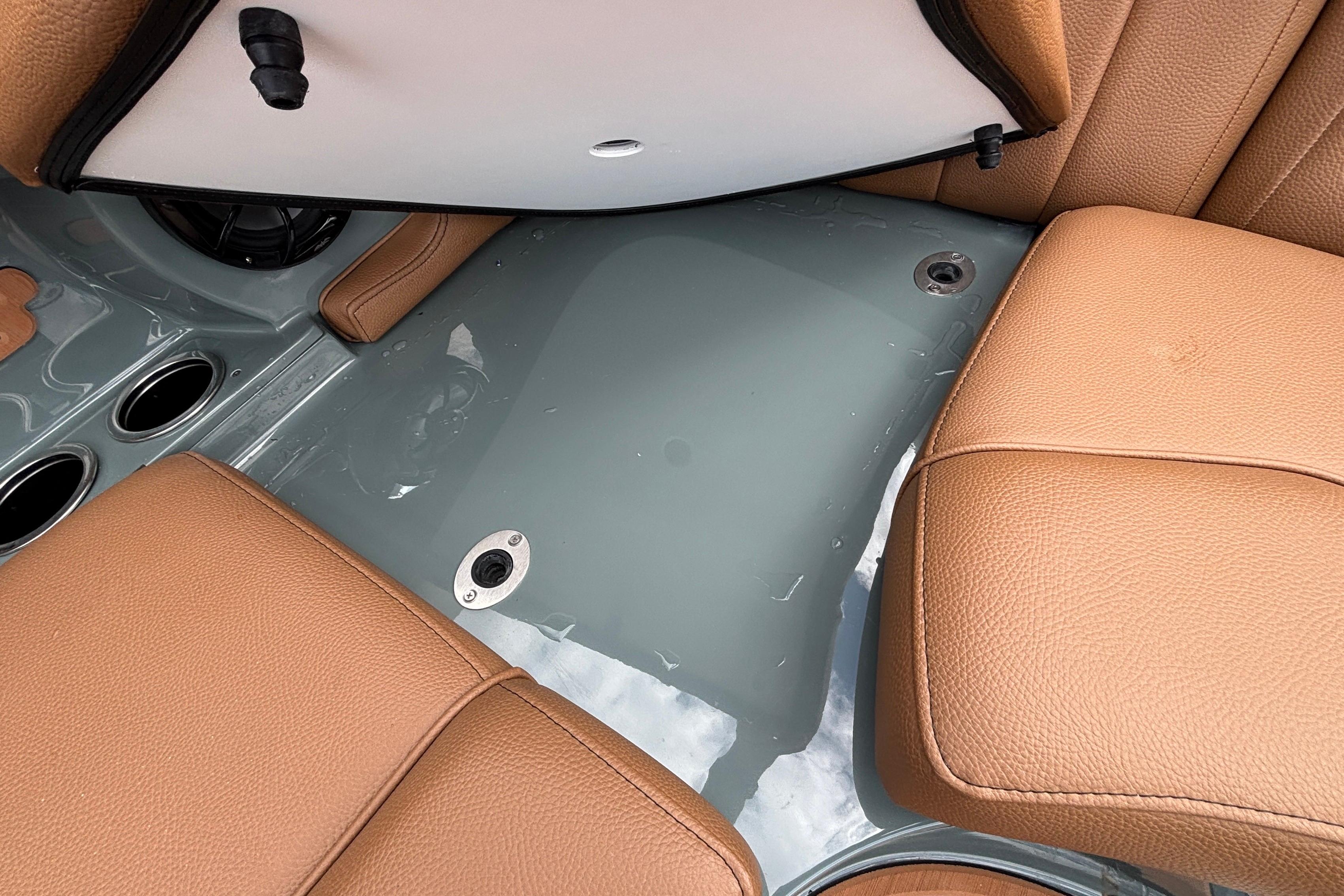2026 MB B52 23 Classic boat interior with tan leather seats and cup holders.
