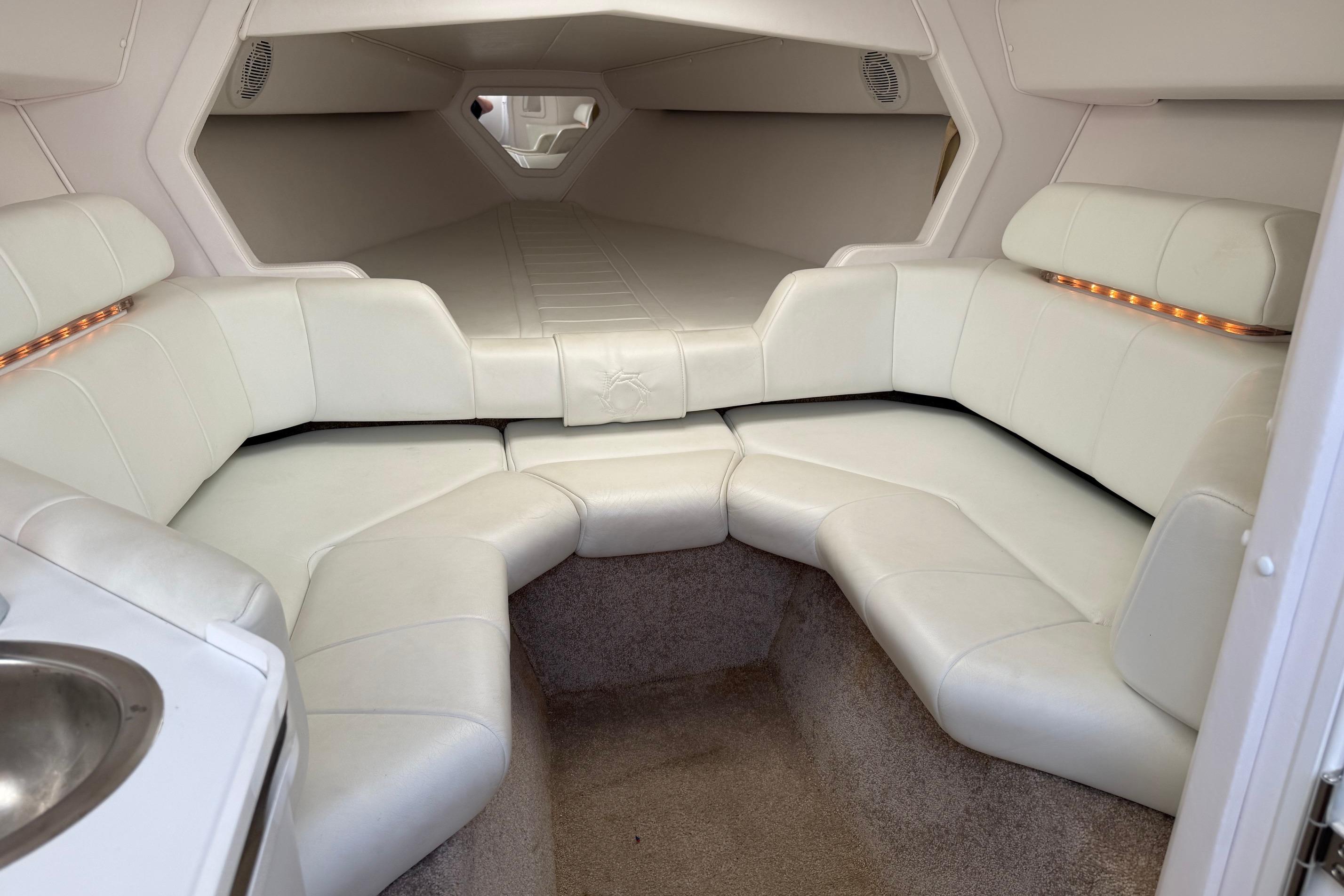Interior of a 1998 Fountain 35 Lightning boat with white leather seating.