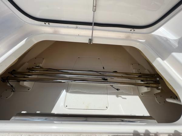 Storage compartment of 2019 Pursuit S 408 Sport boat, open and empty.