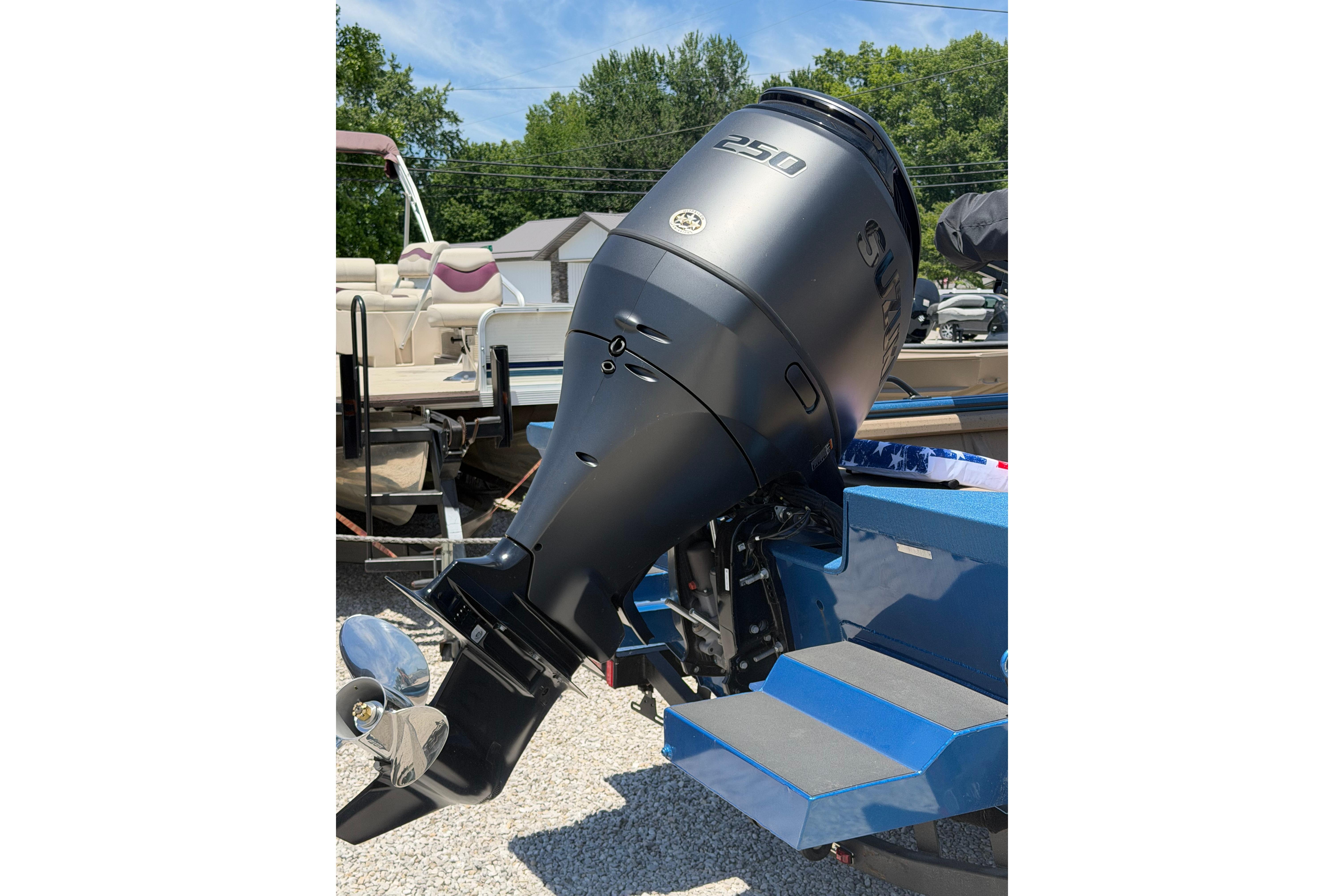 Outboard motor on a 2025 SeaArk Protege 240 boat, parked outdoors.