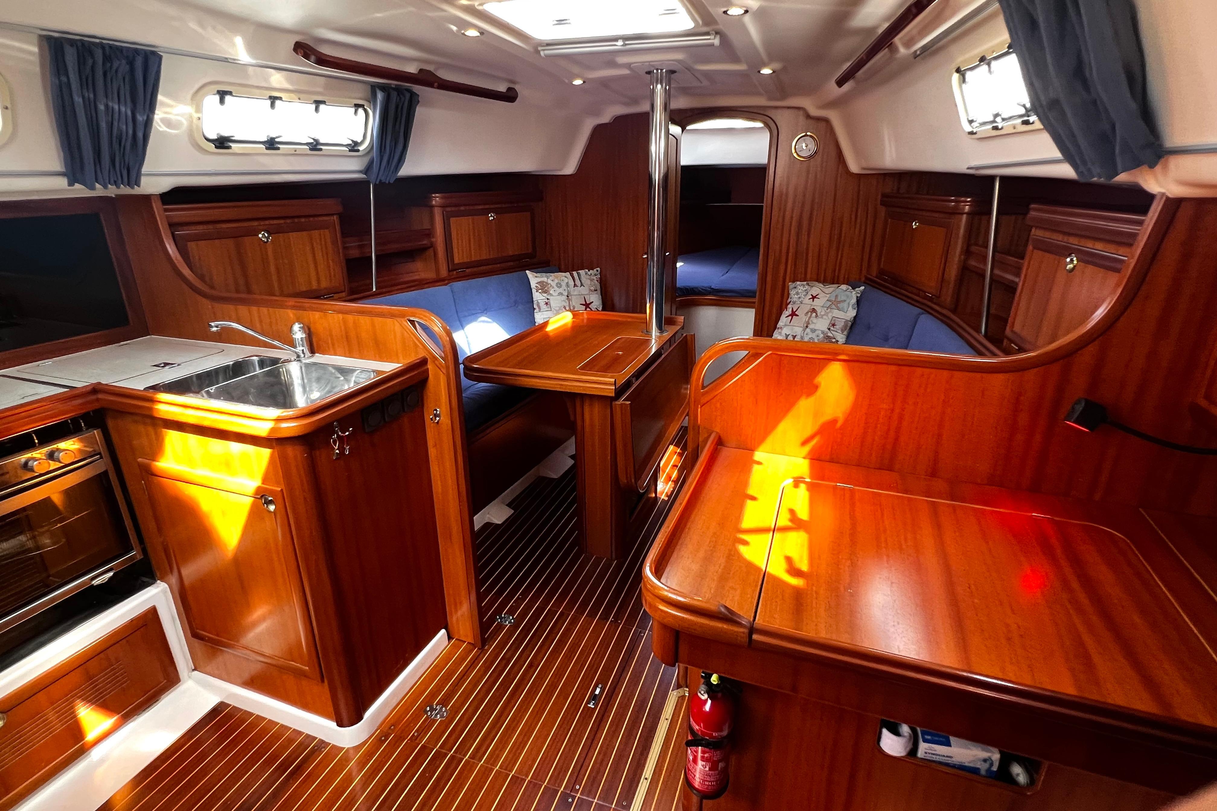 Luxurious 2004 Adria Event 34 yacht interior with wood finish and cozy seating area.