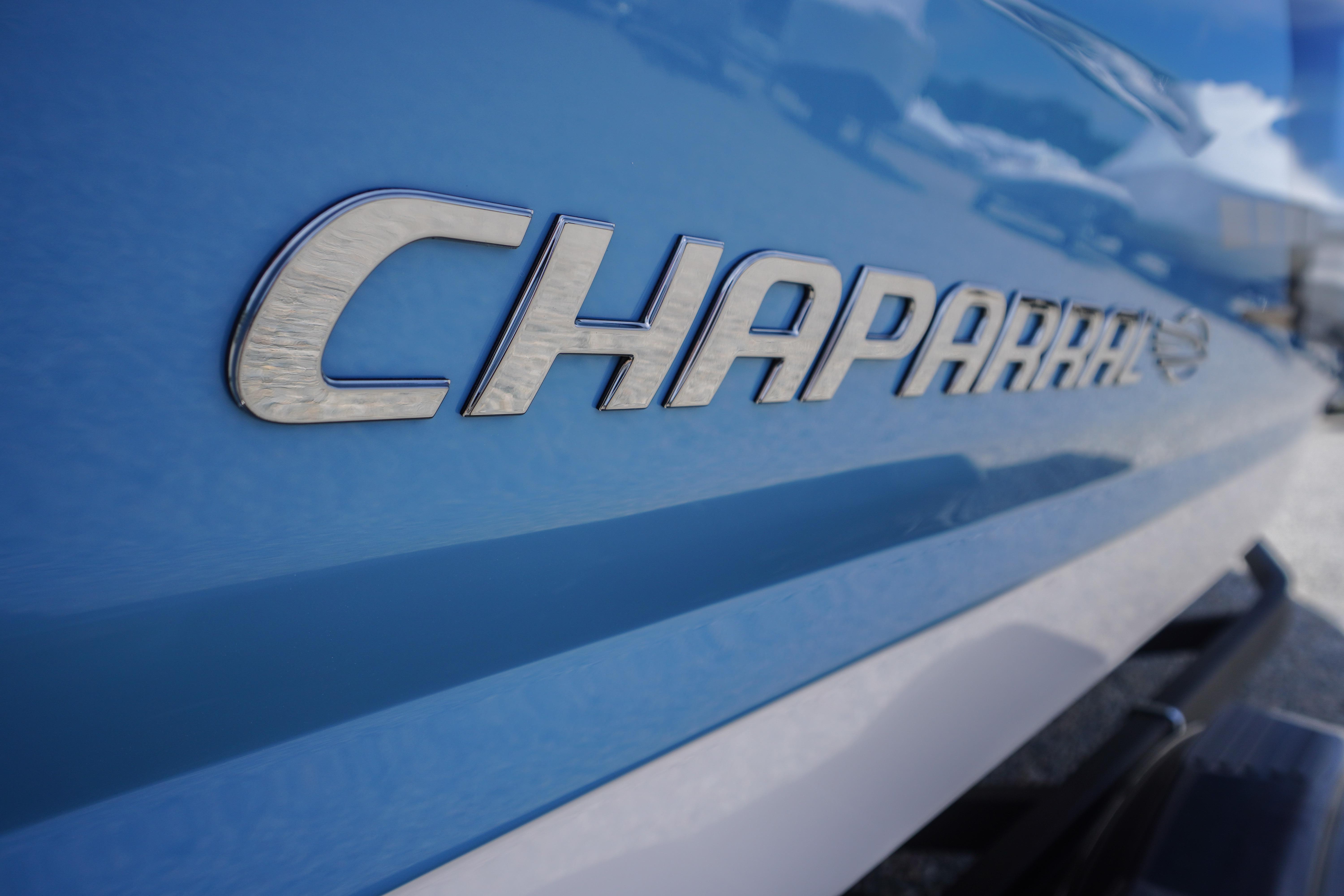 Close-up of 2026 Chaparral 23 SSi OB logo on blue boat exterior.