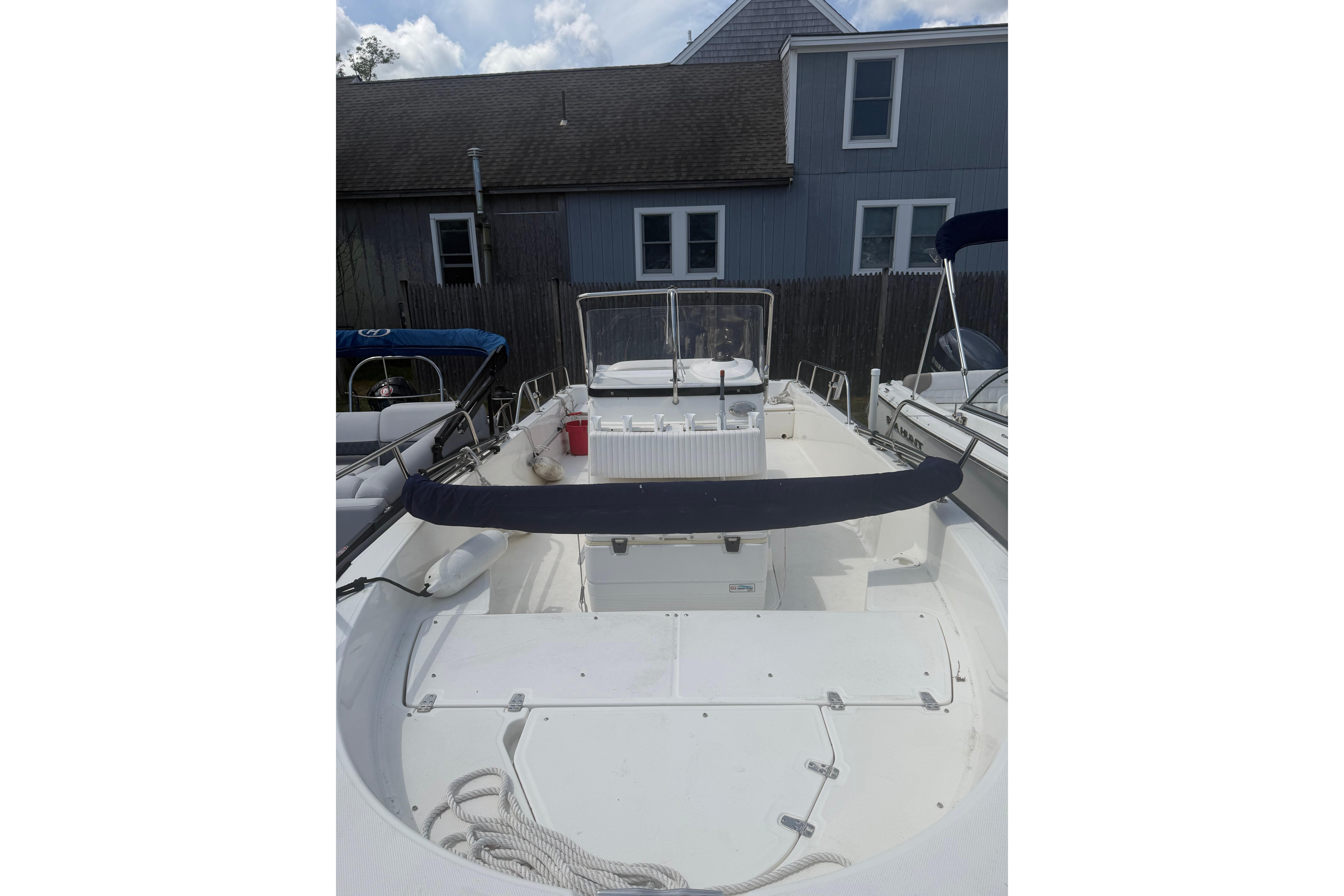 2015 Boston Whaler 210 Montauk boat docked, showcasing spacious deck and seating.