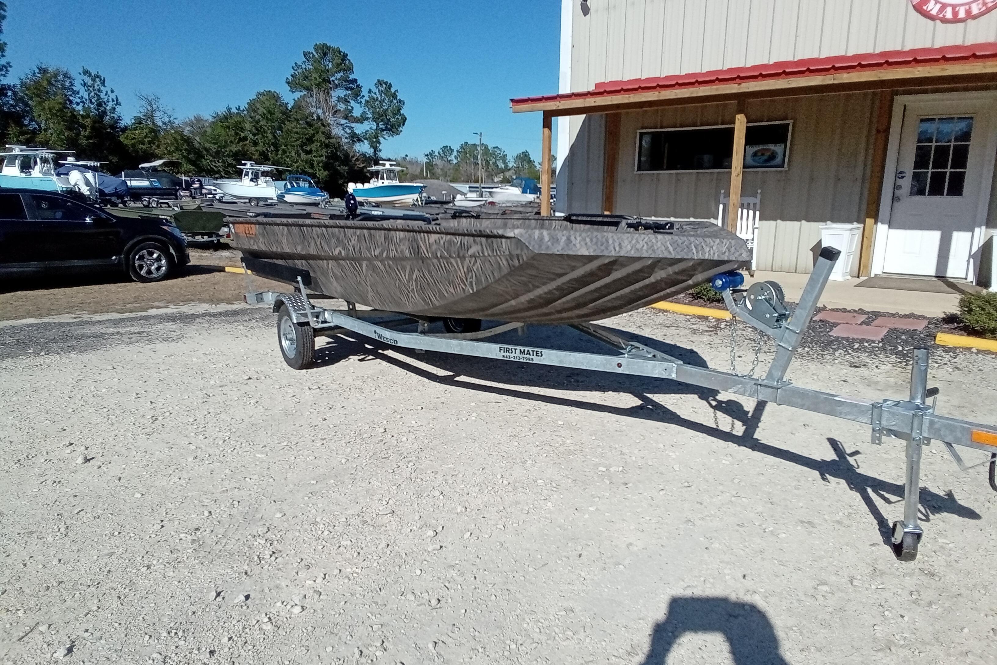 2026 Alweld 1652 Invader boat on trailer, parked outside a building.