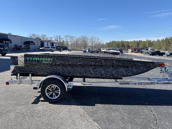 2025 Havoc 1656 VJST boat on trailer, parked outdoors under clear blue sky.