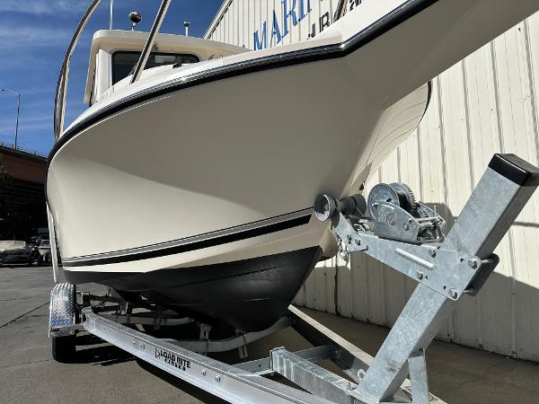 2023 Defiance Admiral 220 EX boat on trailer, parked outdoors.