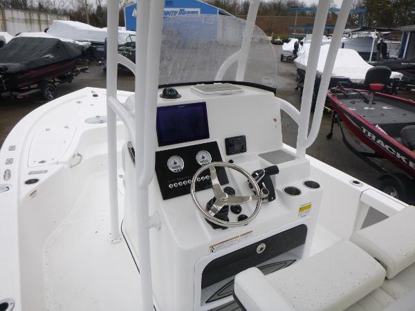 2025 Sea Pro 250 Bay boat cockpit with steering wheel and control panel.