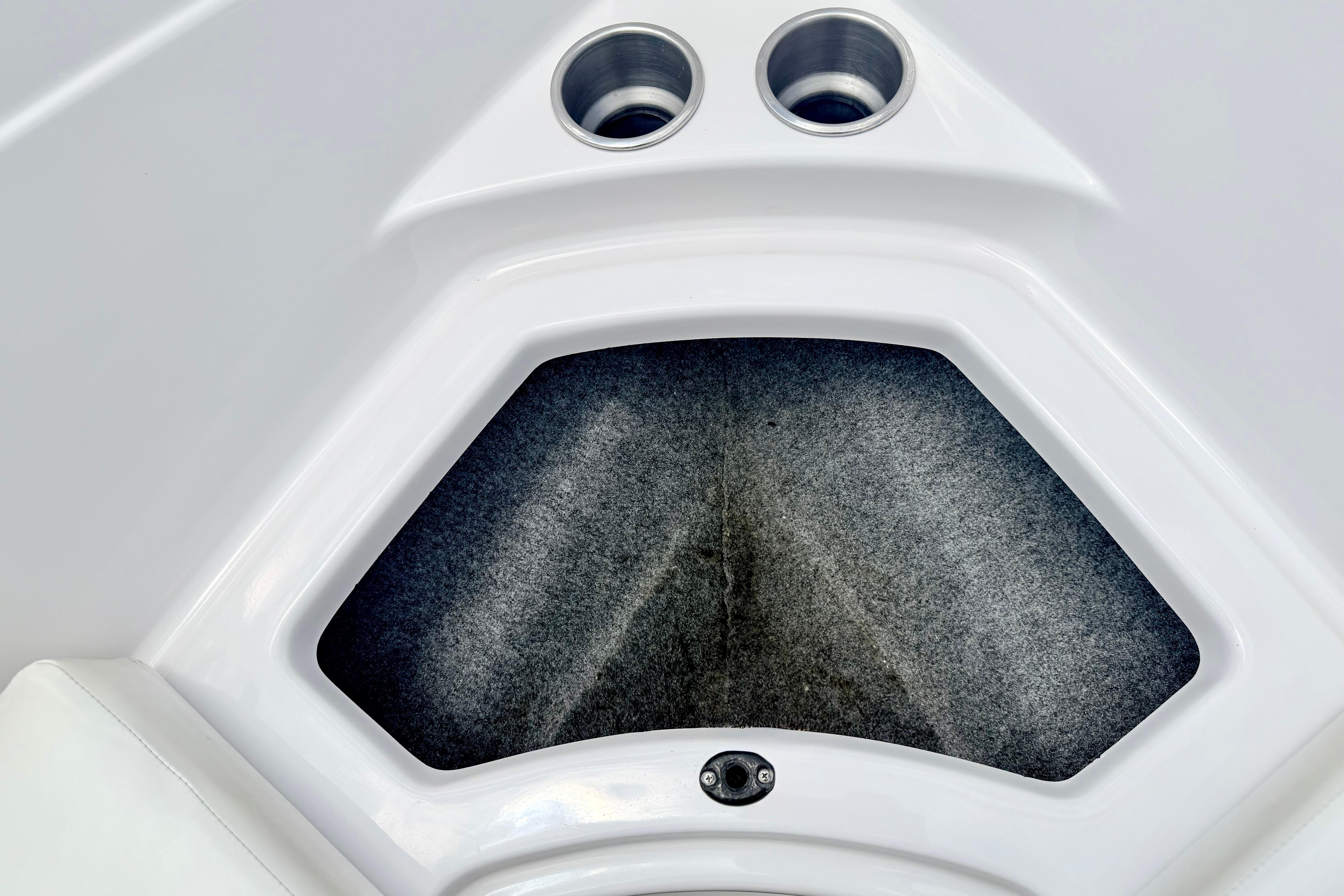 Interior storage compartment of 2018 Glastron GT 185 boat with cup holders.