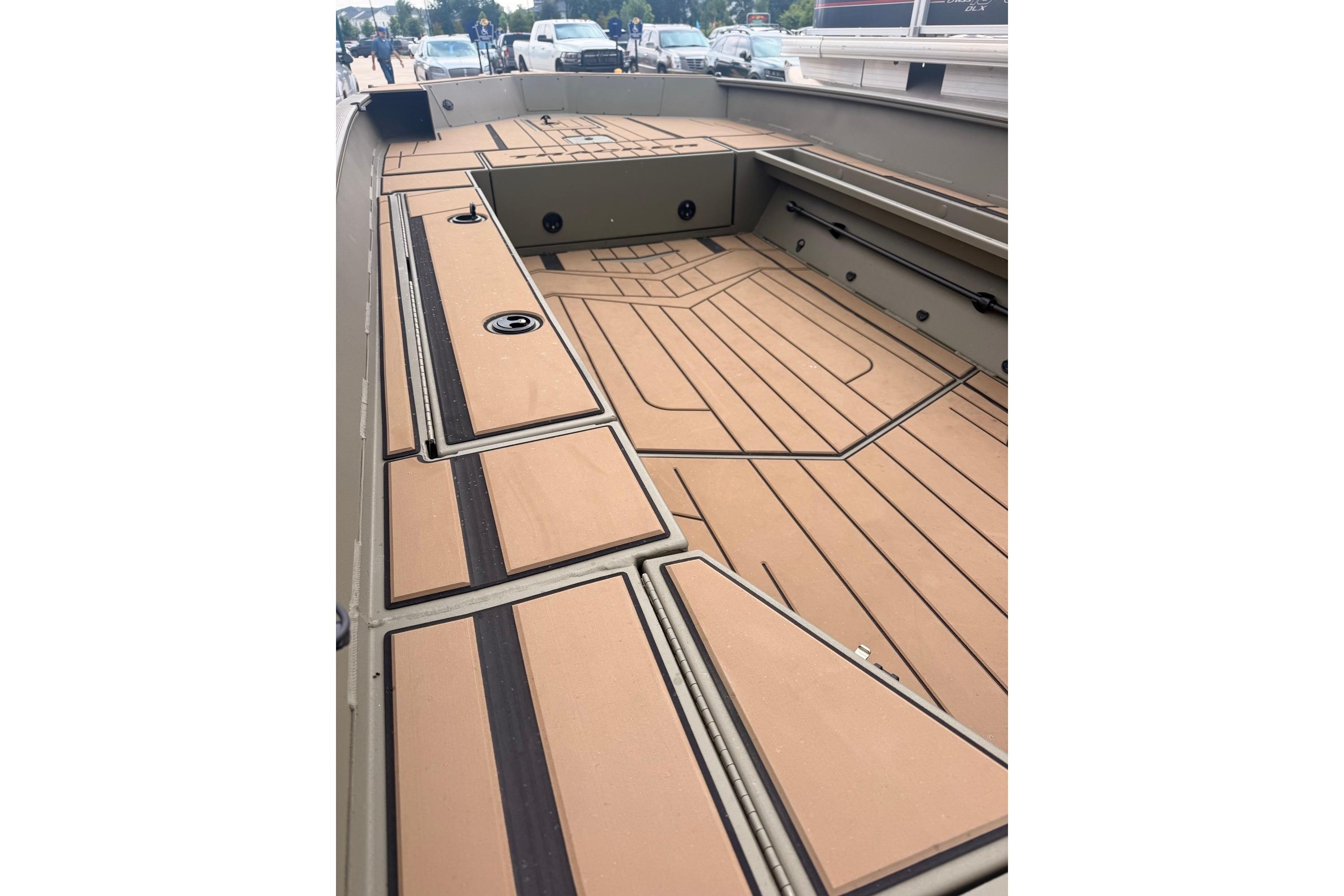 2026 Tracker Grizzly 1756 MARSH boat interior with tan deck and storage compartments.