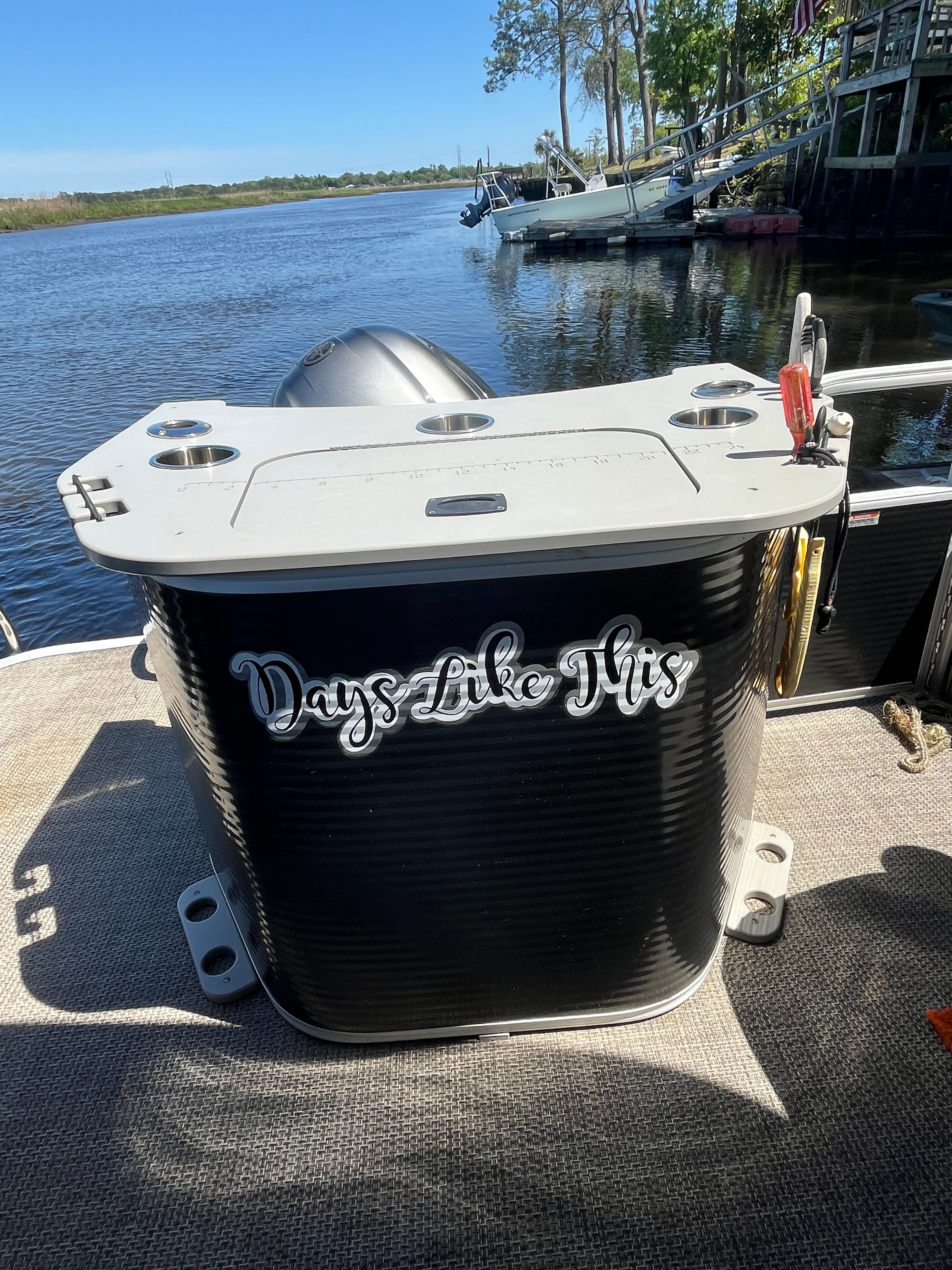 A boat named "Days Like This" on calm water.