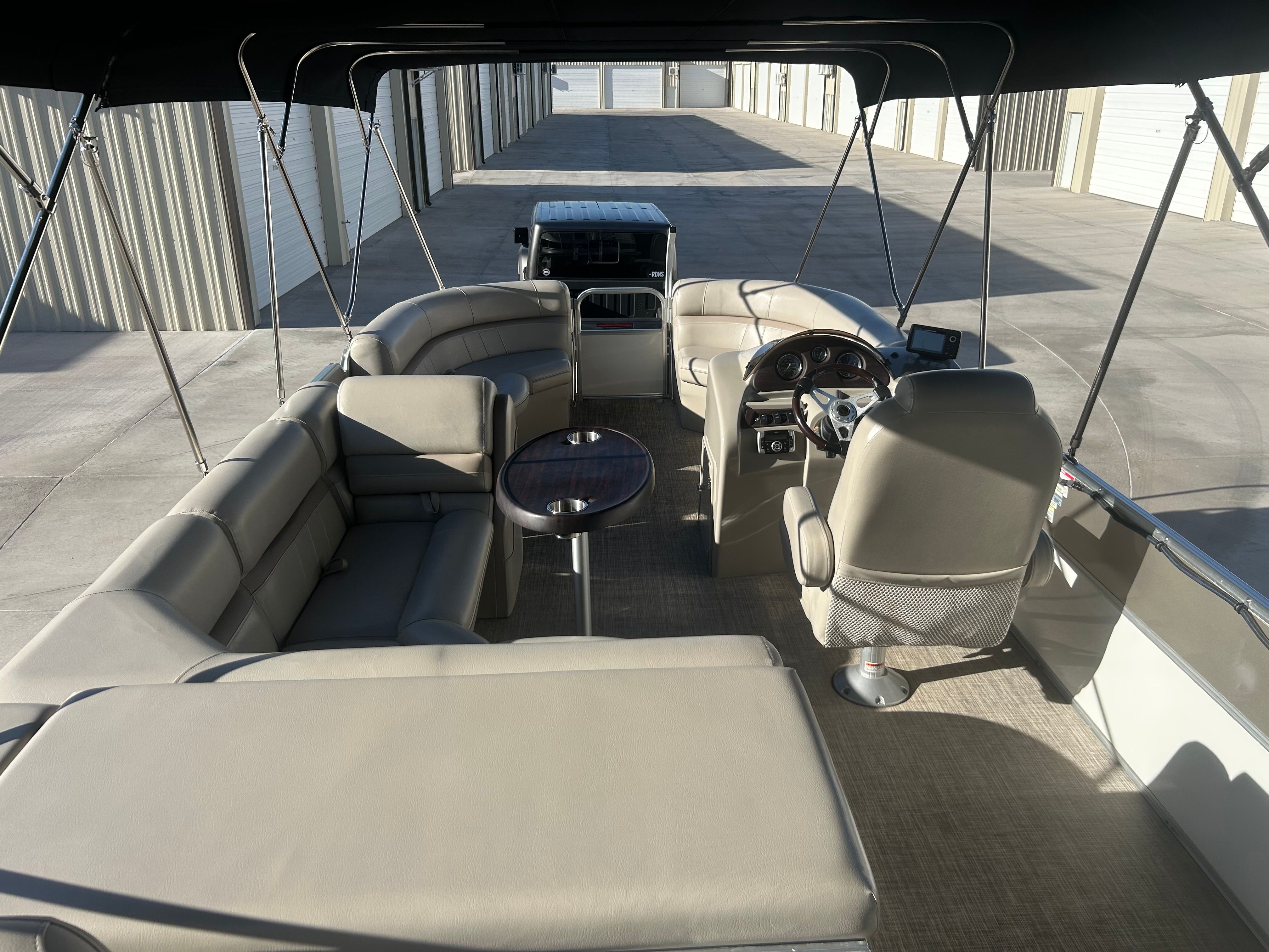 The image shows the interior of a 2018 Berkshire 24RFX CTS pontoon boat with beige seating.