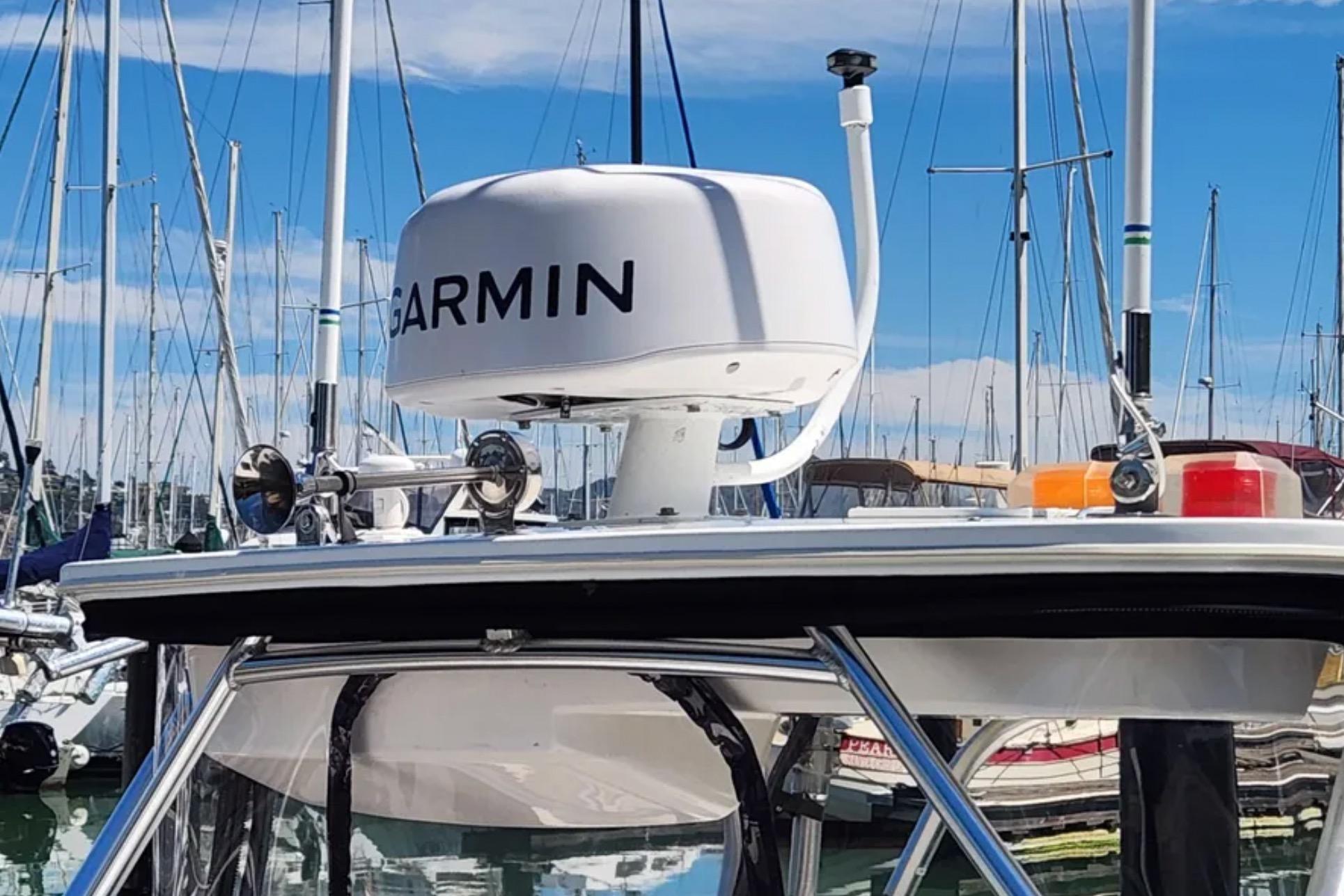 Radar equipment on a 2000 Boston Whaler 21 Conquest boat, docked at a marina.