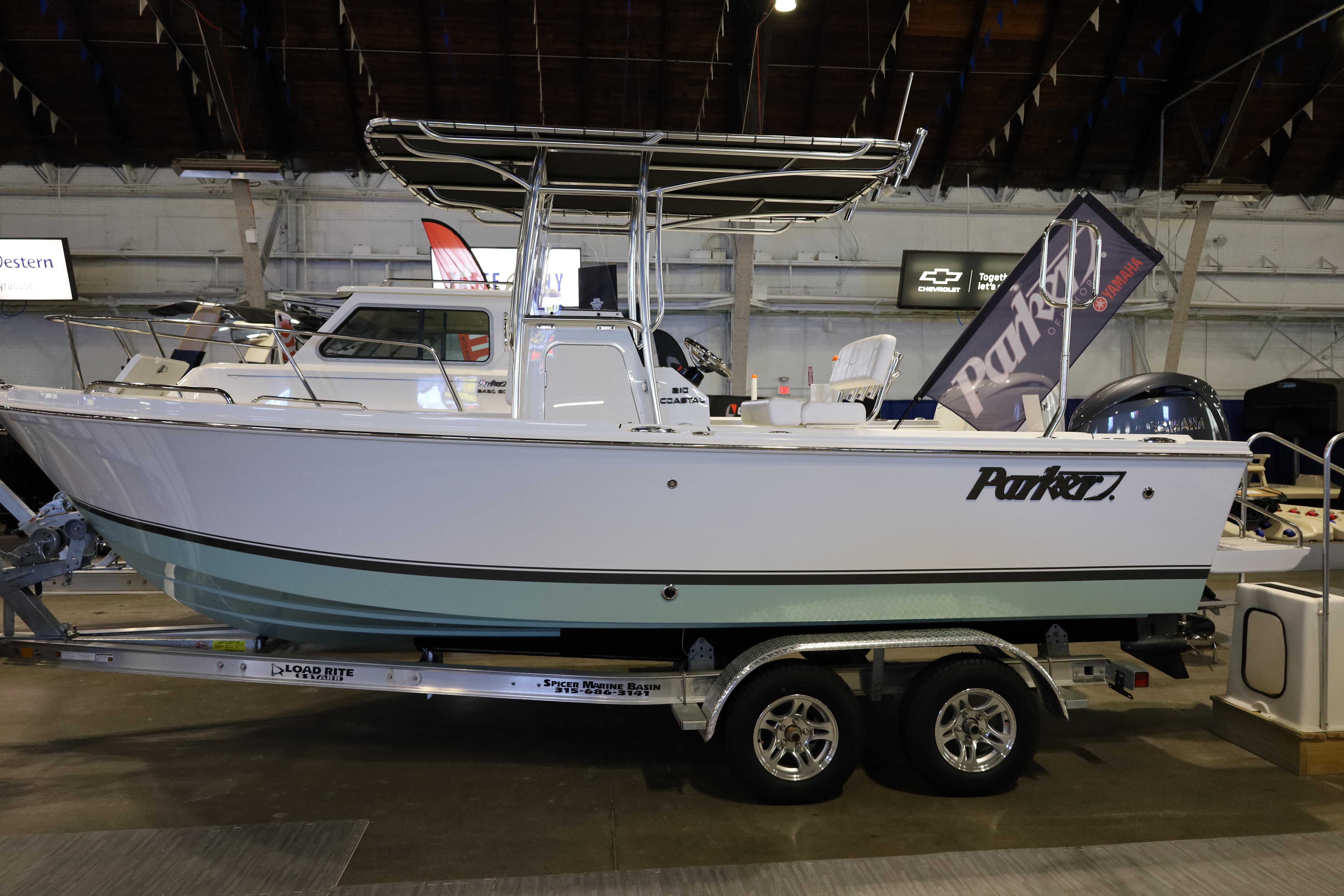 2026 Parker 210 Coastal boat on display in an indoor showroom.