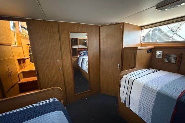 Interior of 1980 Chris-Craft 381 Catalina yacht with cozy cabin and wooden furnishings.