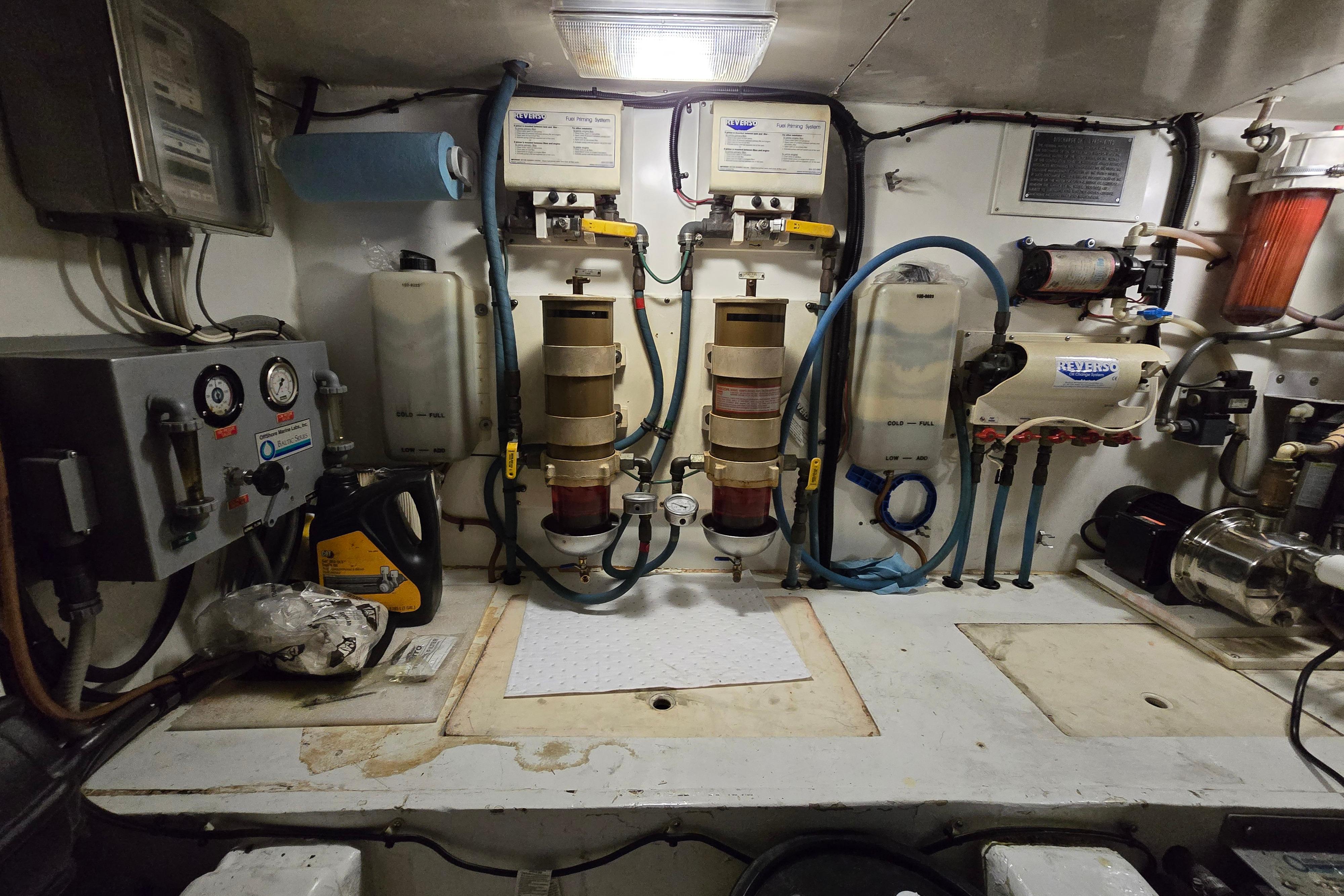 Engine room of a 2001 Cavileer 53 Convertible yacht, featuring various mechanical components.