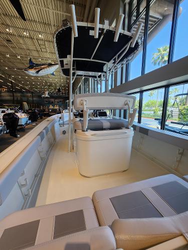2025 Mako 214 CC boat interior with seating and canopy, displayed indoors.