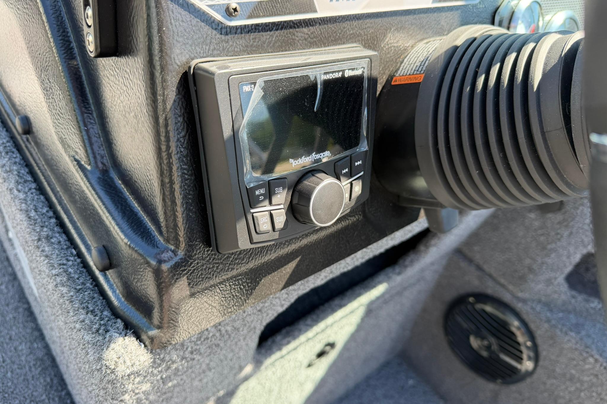 Control panel of 2027 Lund 1775 Impact XS Sport boat with audio system.