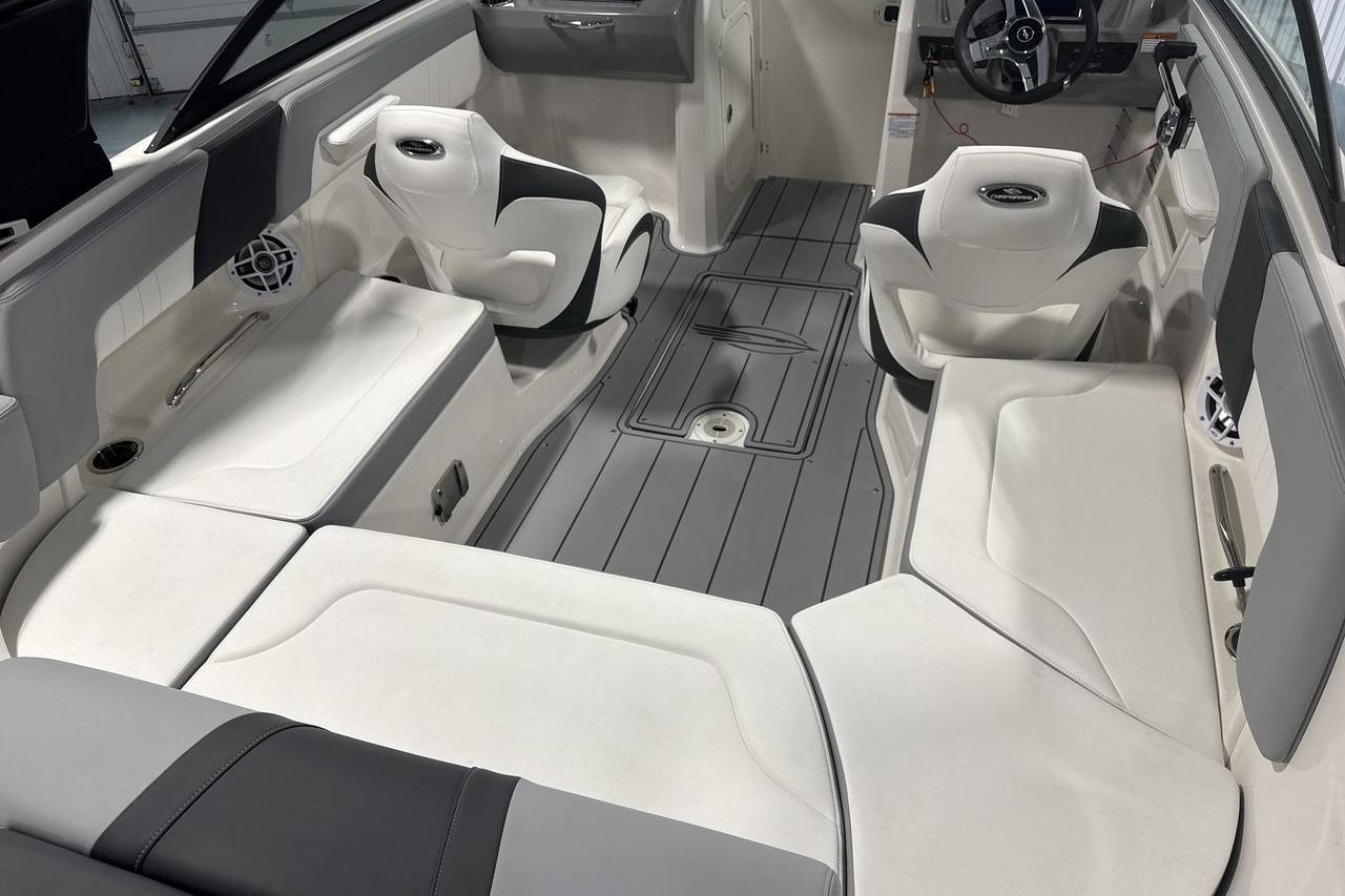 Interior of a Chaparral 23 SSi boat with gray flooring and white seating.