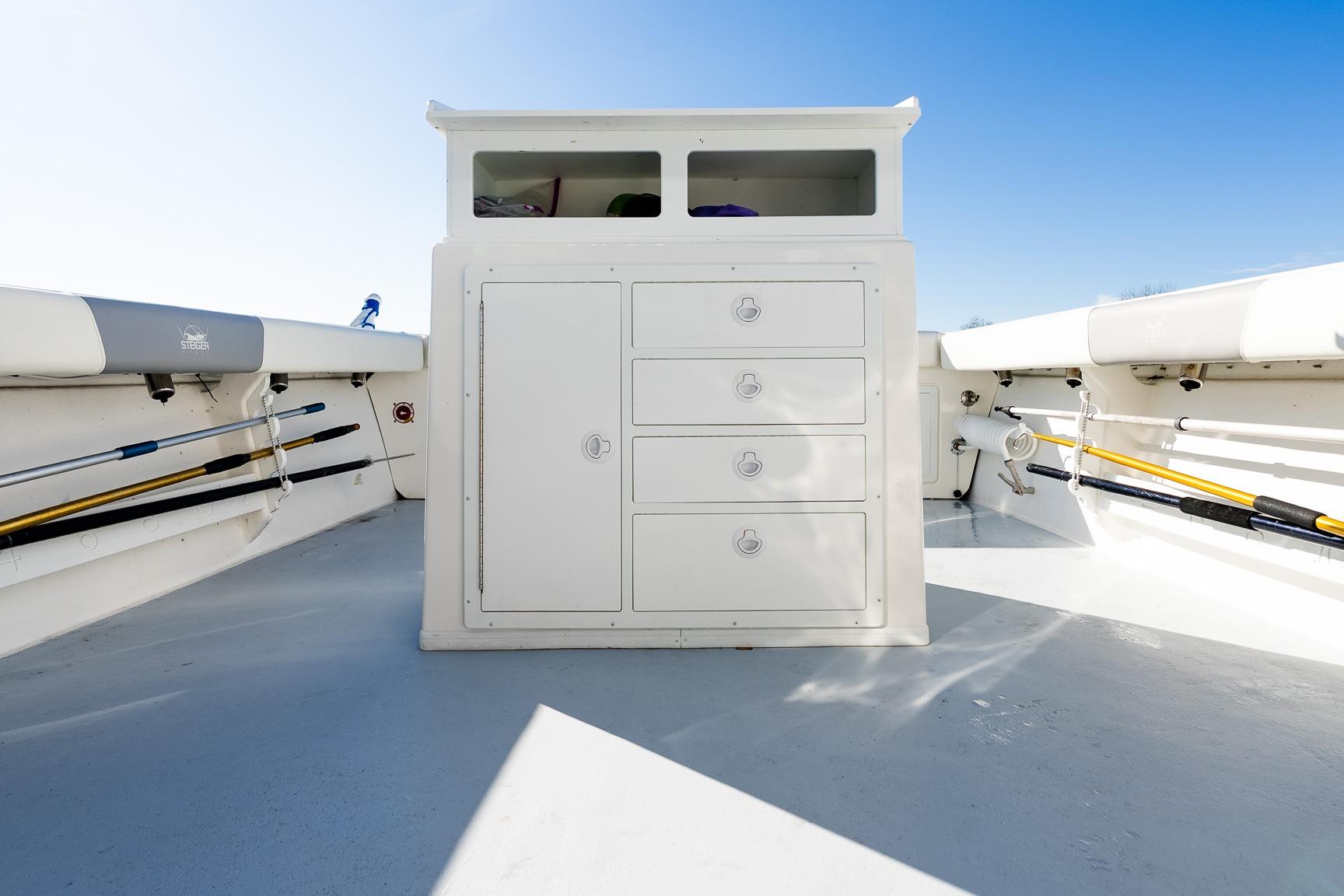 2024 Steiger Craft 31 Fisherman boat interior with storage compartments and fishing rod holders.
