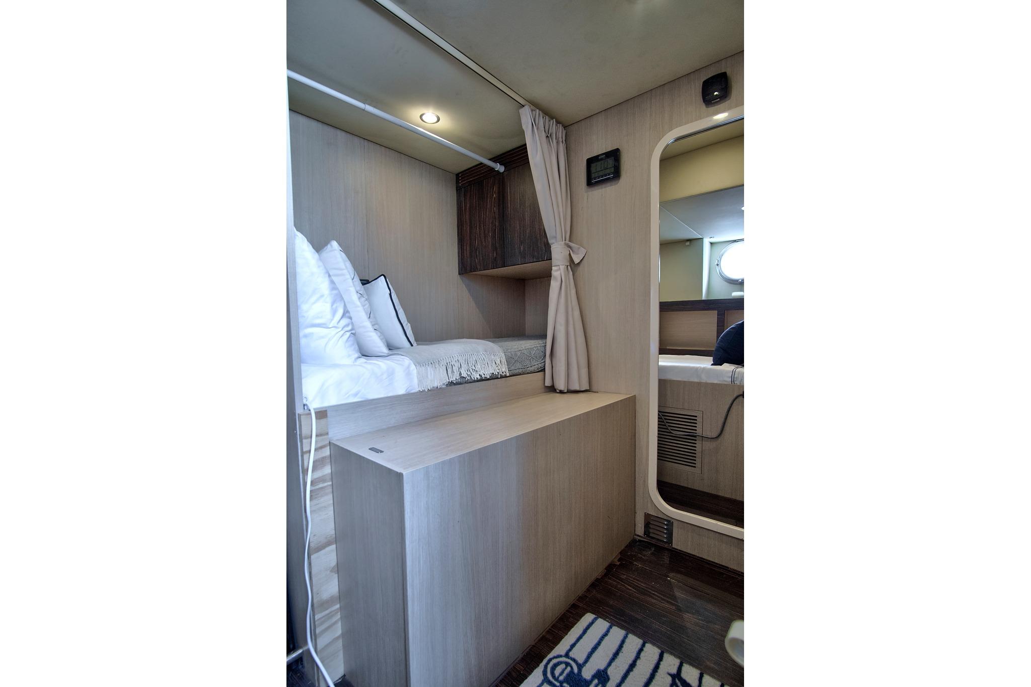 Interior cabin of 2017 Azimut 72 Flybridge yacht, featuring cozy bedding and modern design.