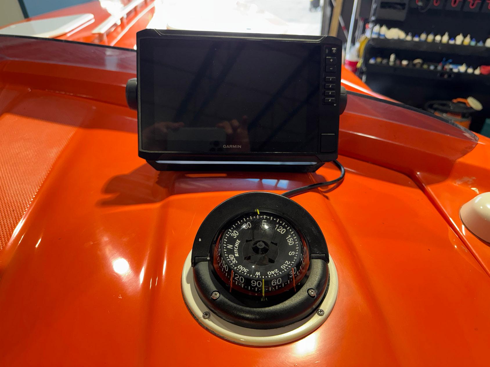 2007 Baja 35 Outlaw boat dashboard with compass and Garmin device.