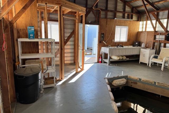 Interior of a 1960 custom boathouse with rustic wooden walls and simple furnishings.