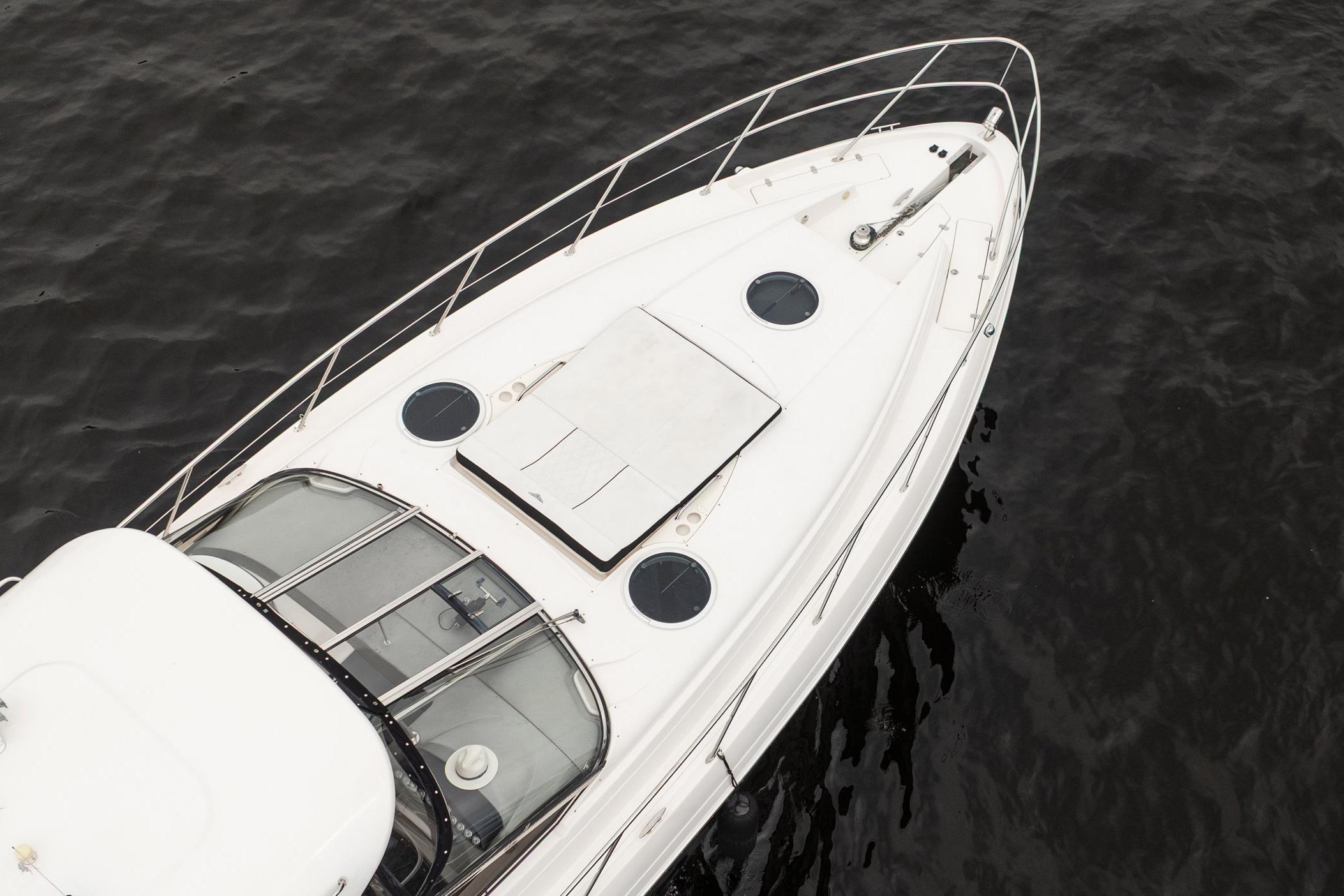 2008 Regal Commodore 4460 yacht on dark water, aerial view.
