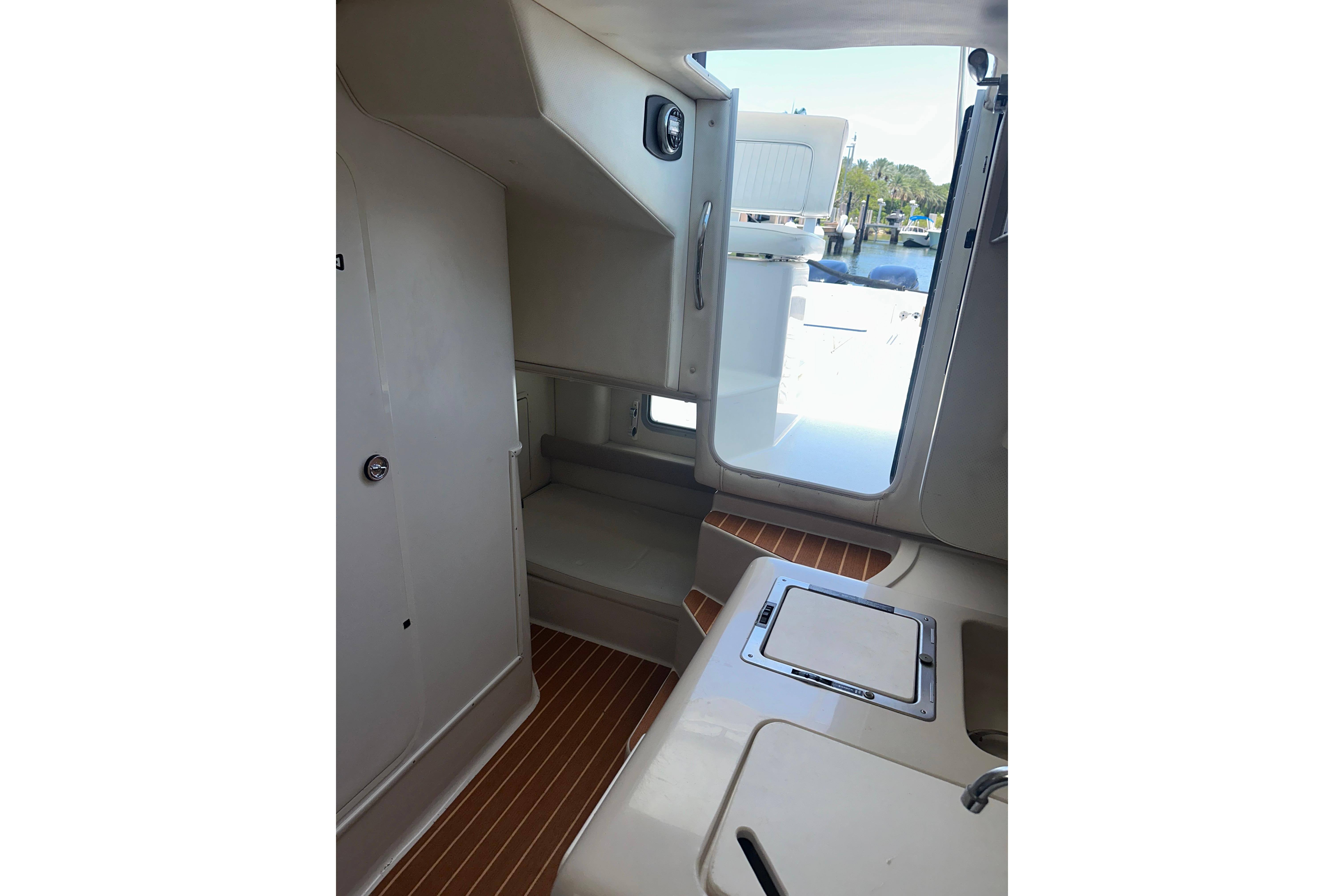 Interior view of 1994 Pro-Line 2950 Walkaround boat cabin with seating and hatch.