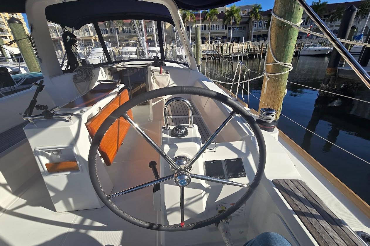 Cockpit view of 2023 Beneteau Oceanis 38.1 yacht docked at marina.