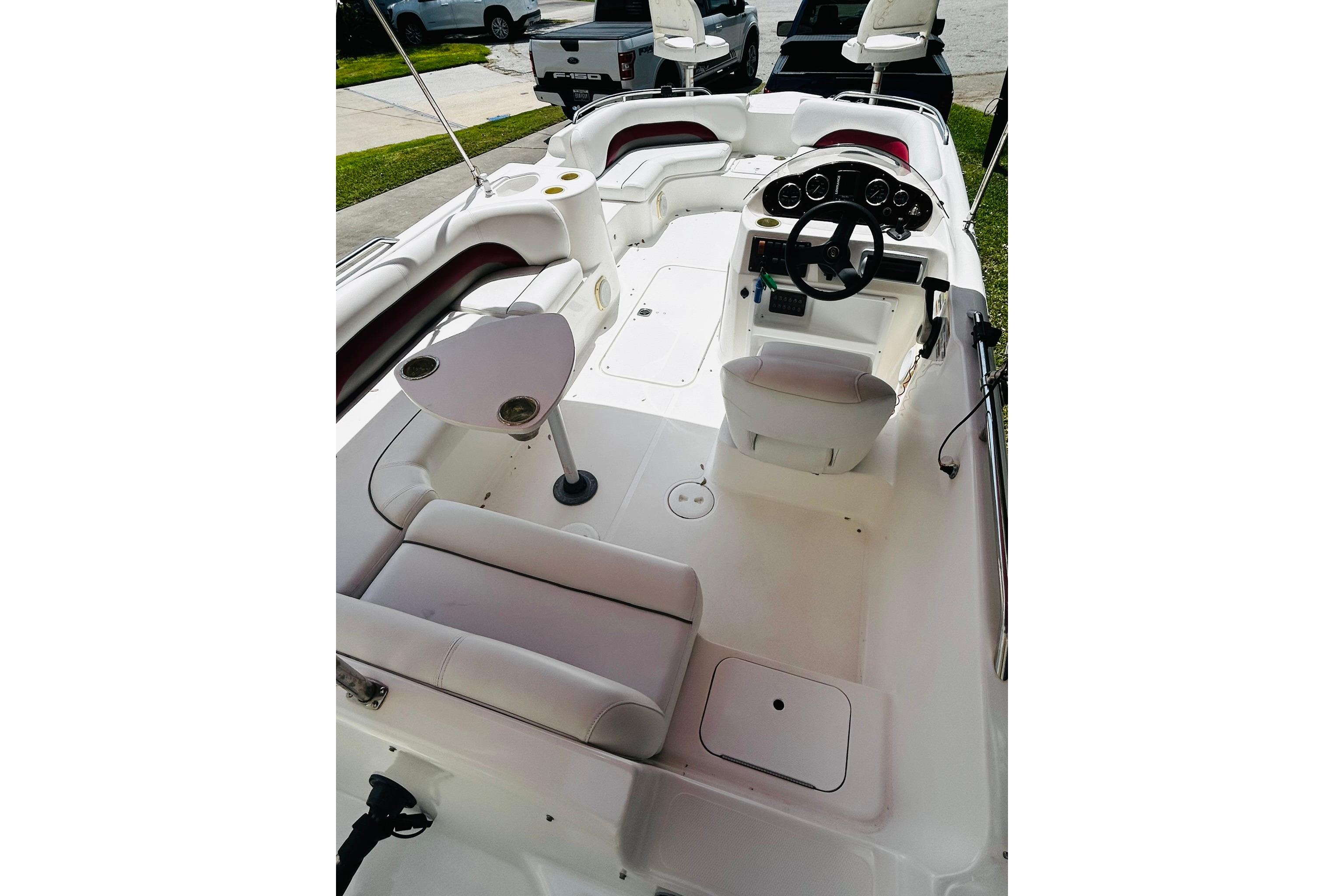 2013 Hurricane SunDeck Sport 201 OB boat interior with seating and steering console.