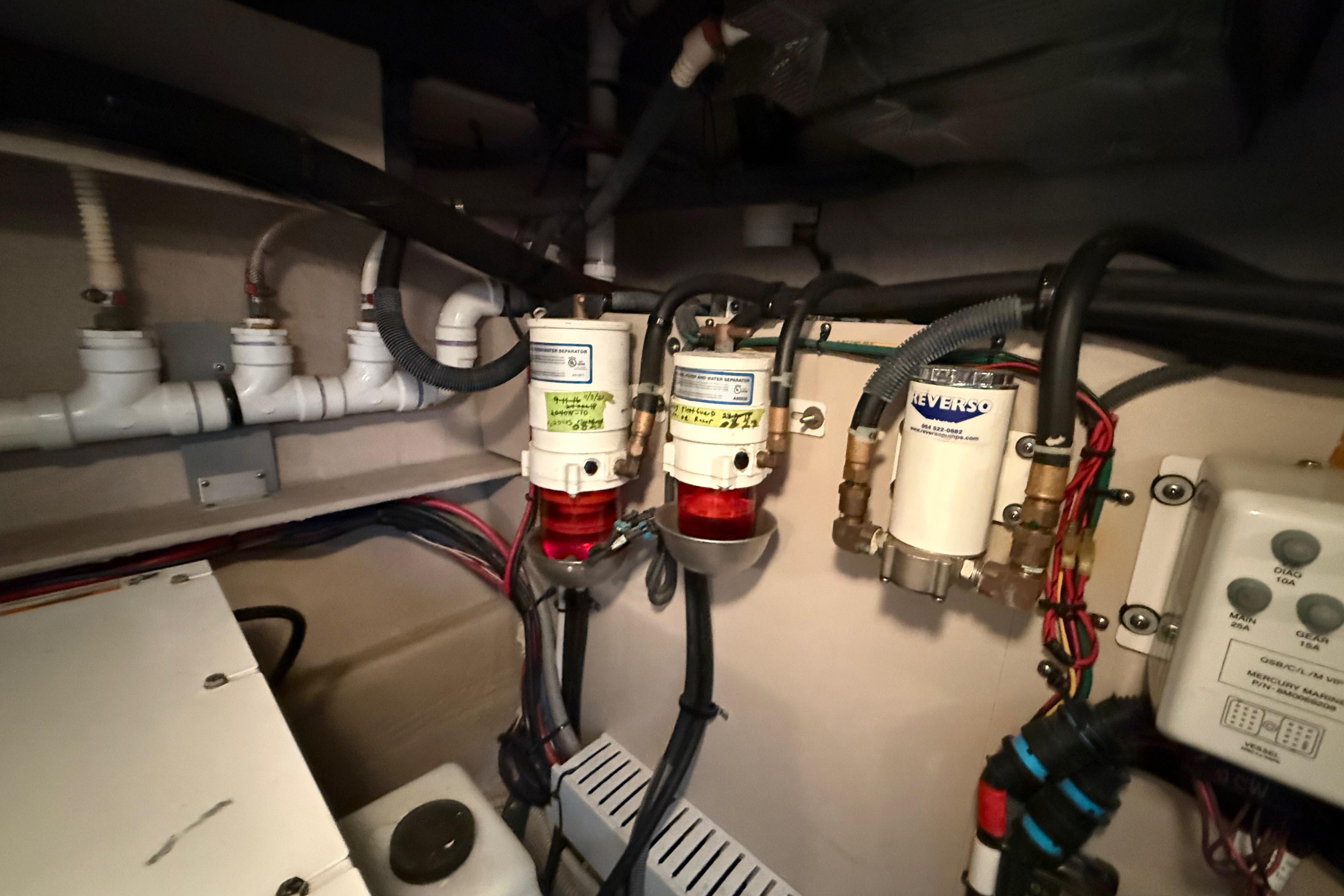 Engine room of 2016 Sea Ray Sundancer 510 with fuel filters and wiring.