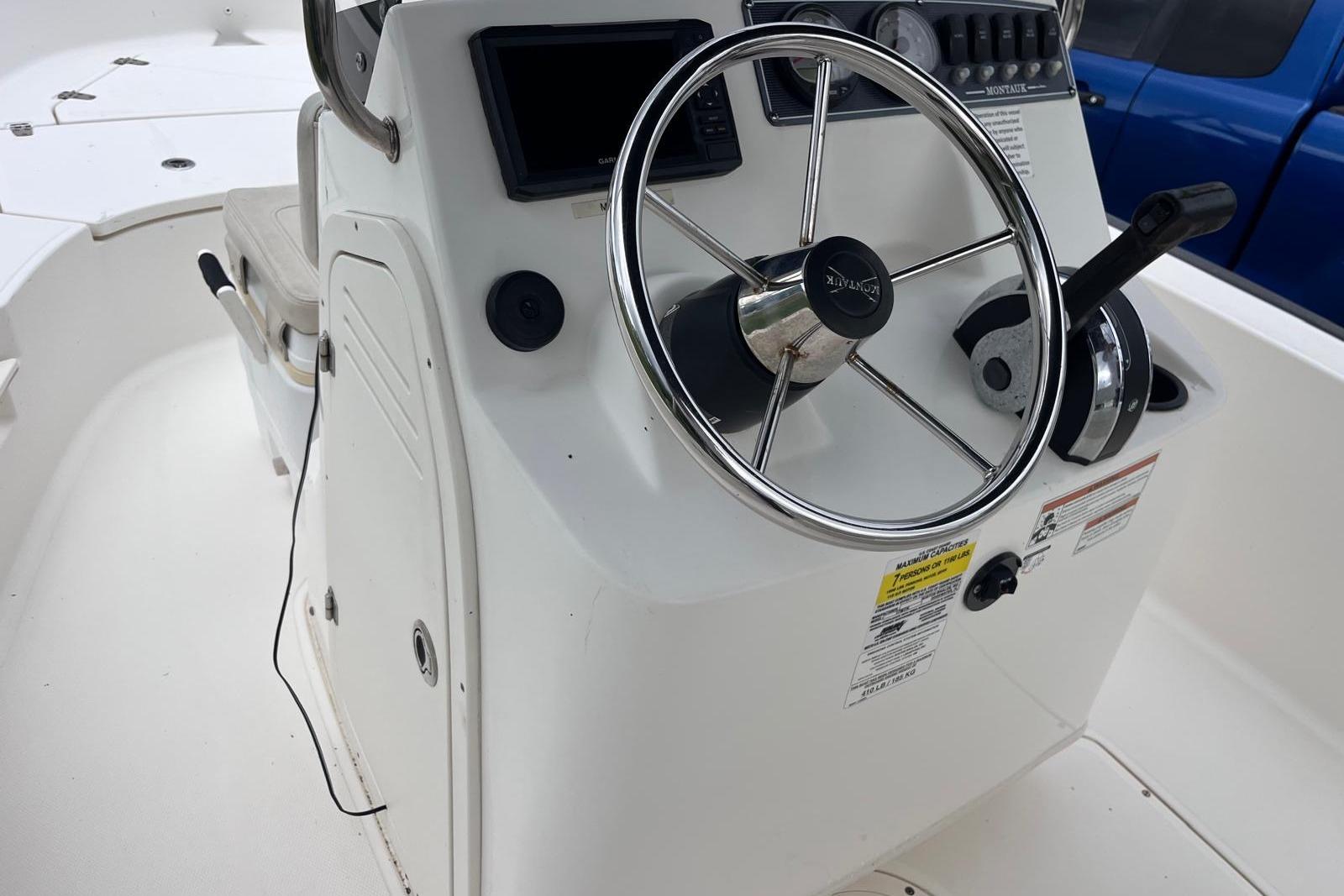 2020 Boston Whaler 170 Montauk boat console with steering wheel and controls.