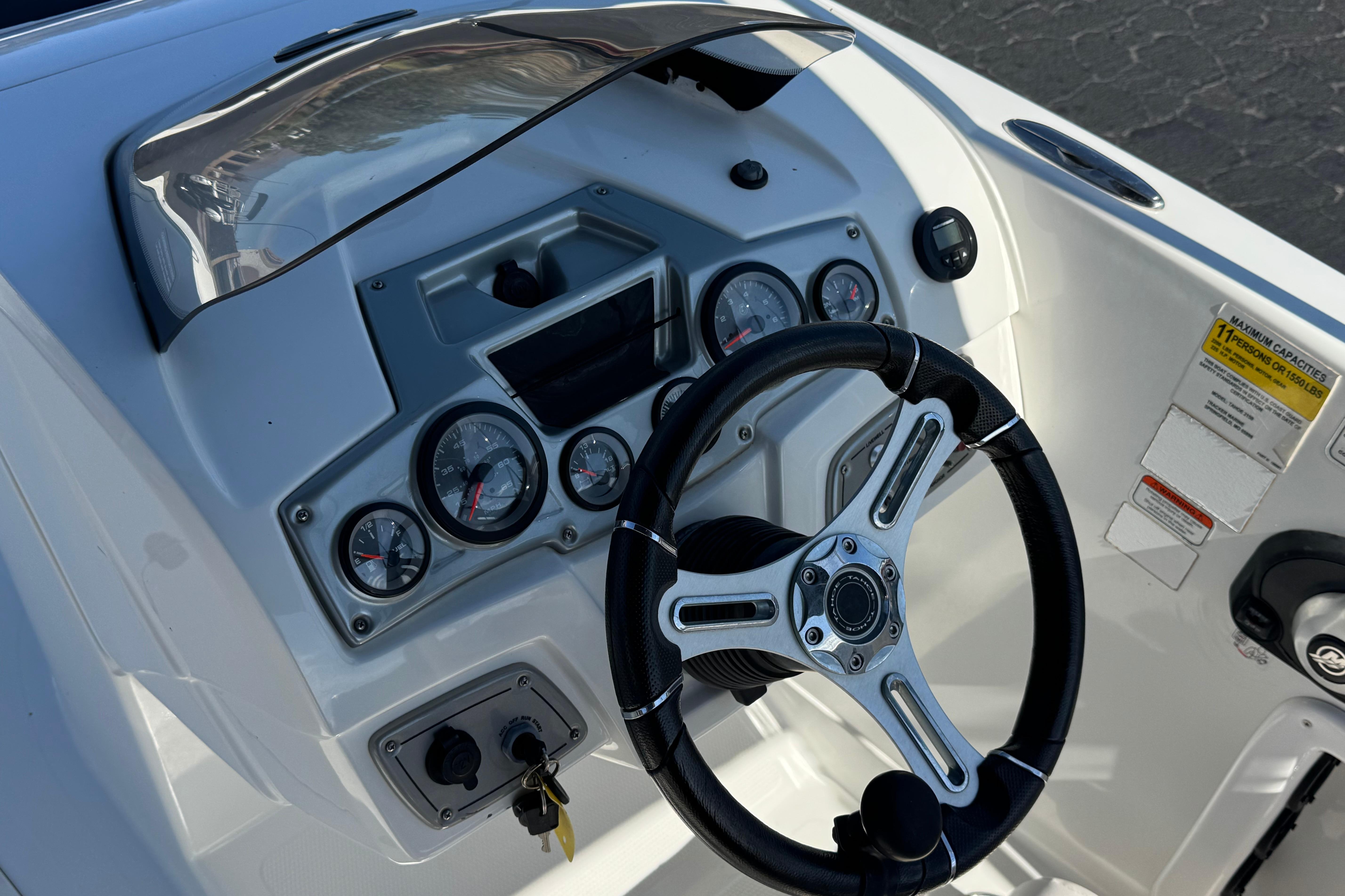 Steering console of a 2019 Tahoe 2150 boat with gauges and controls.