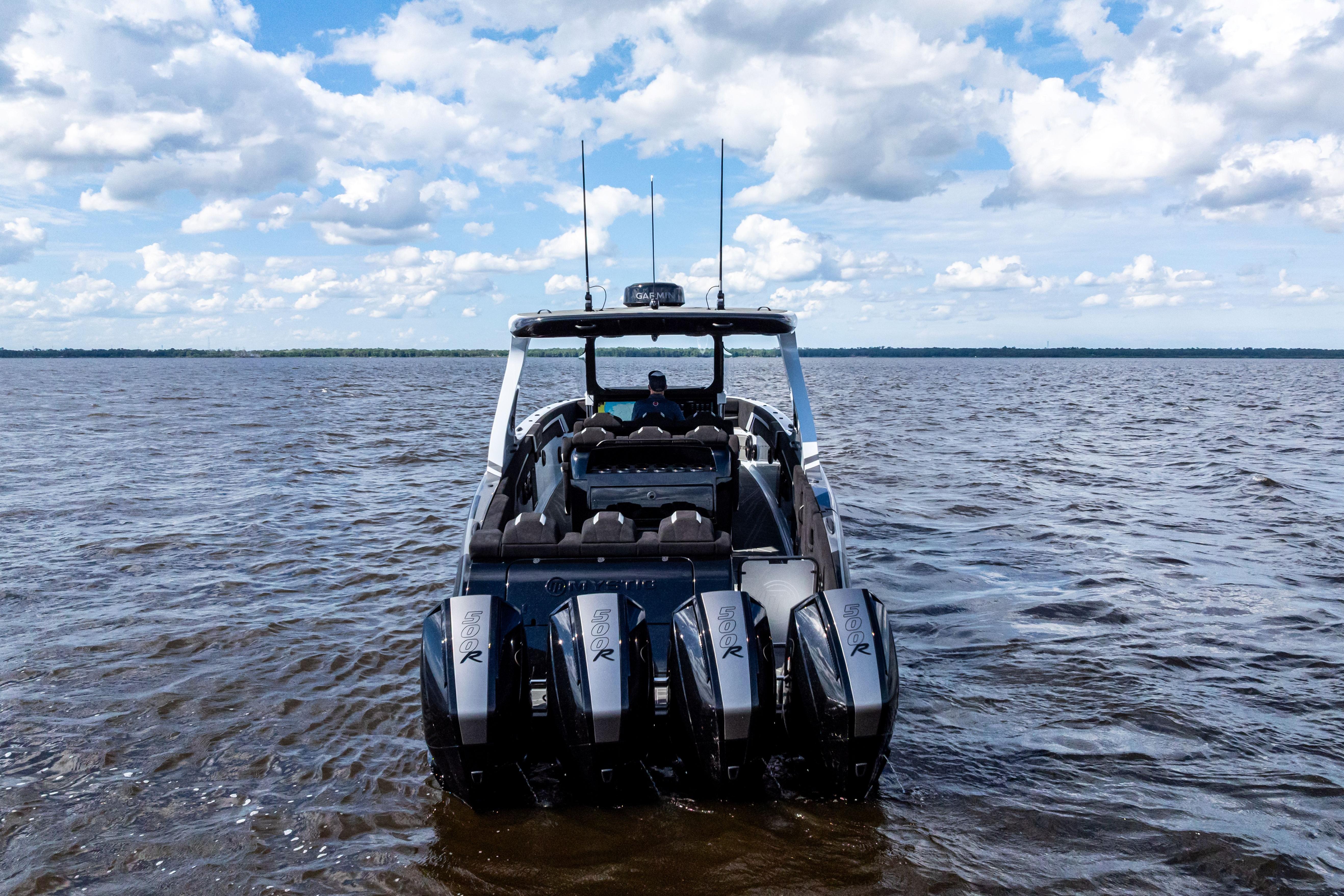 2027 Mystic Powerboats M4200 on open water, showcasing powerful engines and sleek design.