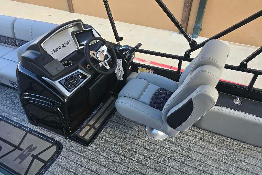 2026 Ranger 223FC boat interior with steering console and cushioned seating.