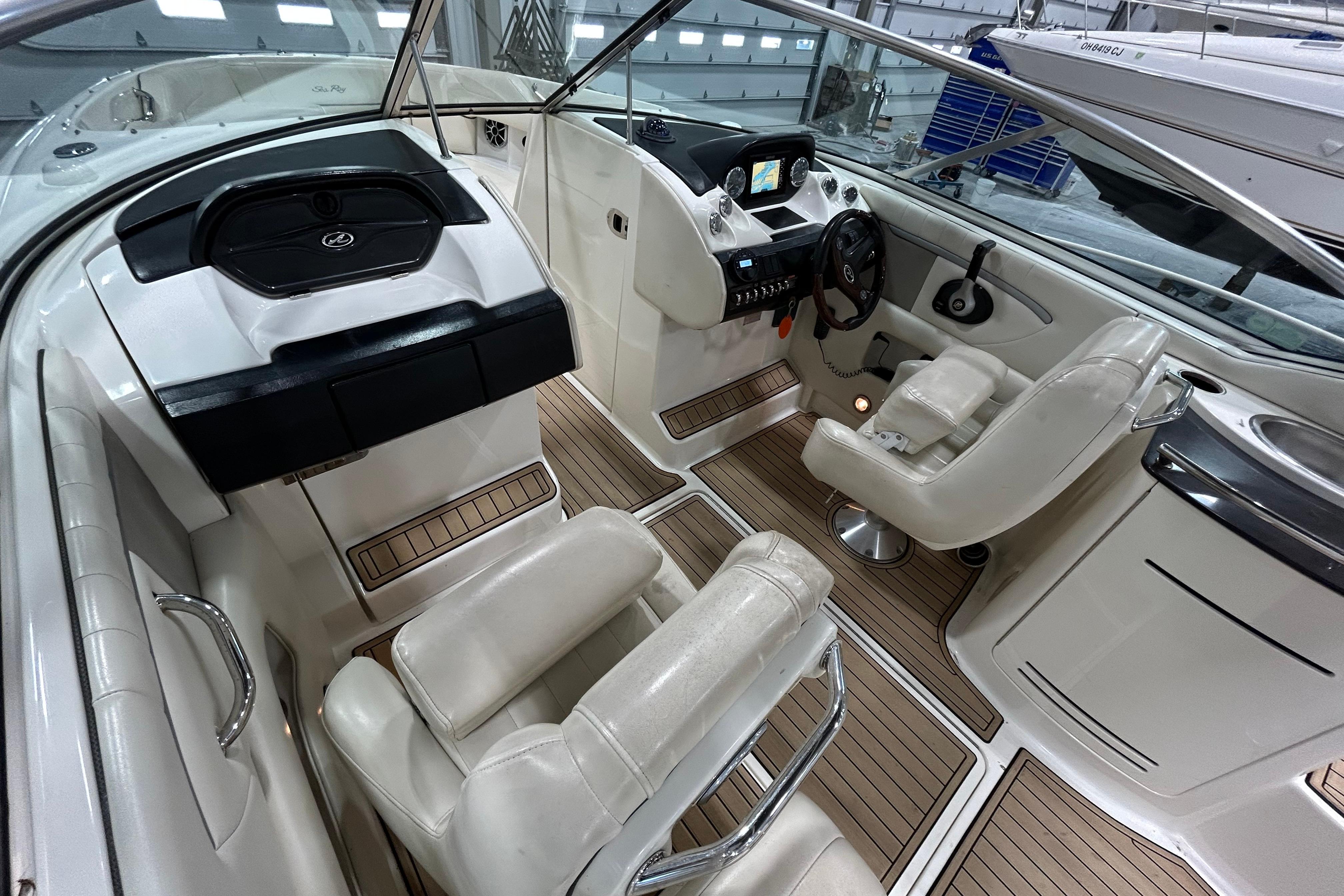 Interior of a 2006 Sea Ray 270 SLX boat with luxurious seating and modern dashboard.