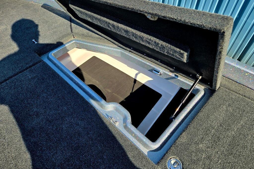 Open storage compartment on 2026 Skeeter ZXE20 boat deck, showcasing interior space.