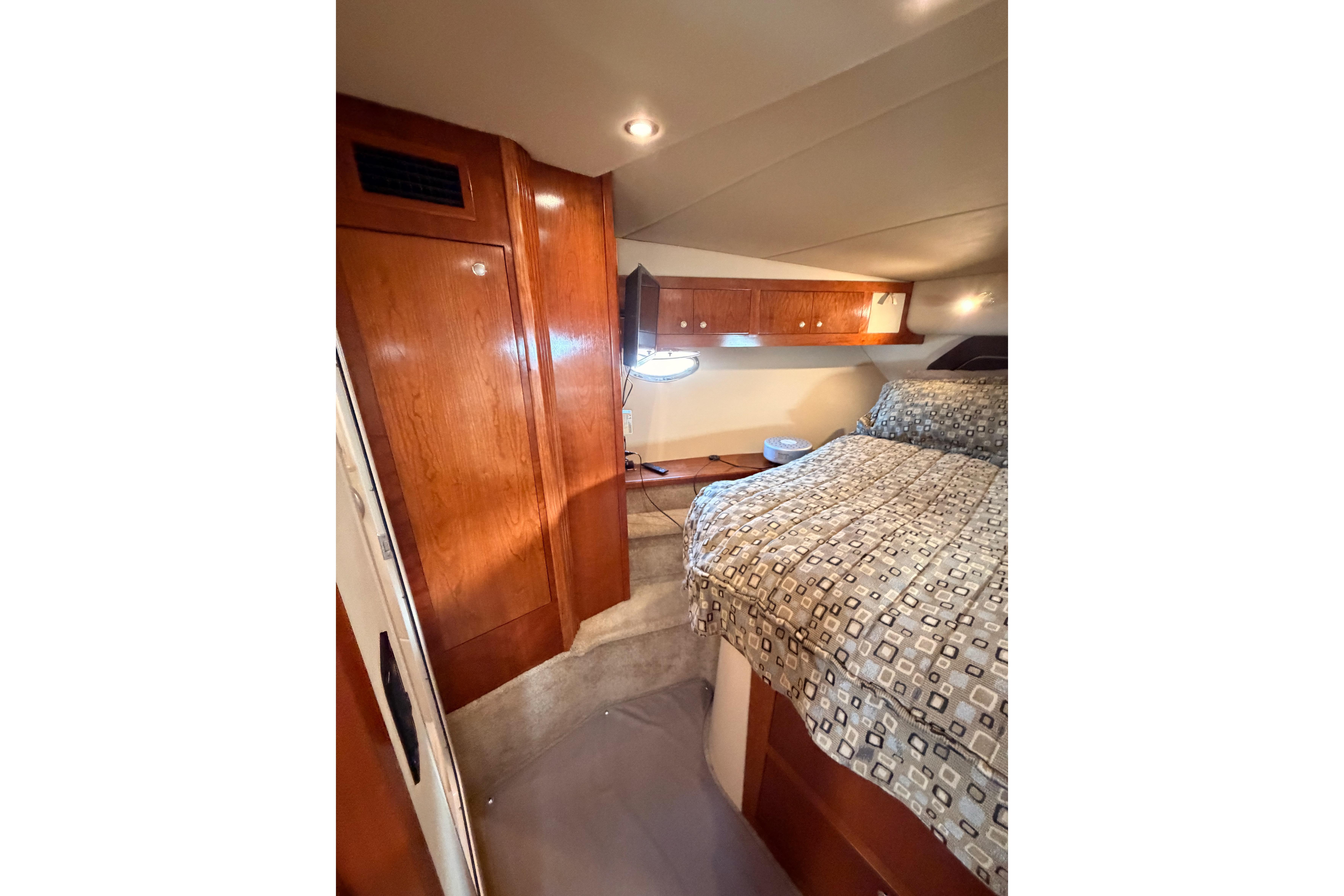 Luxurious cabin interior of 2005 Cruisers Yachts 405 Express Motoryacht with wood finishes.