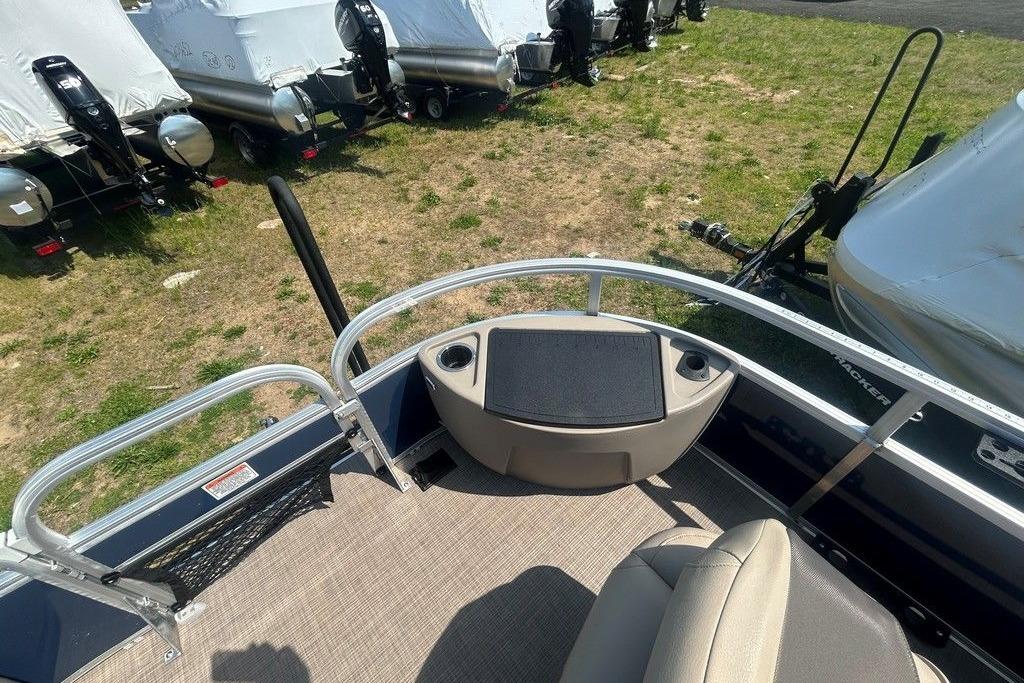 2023 Sun Tracker Bass Buggy 18 DLX pontoon boat interior with seating and railing.
