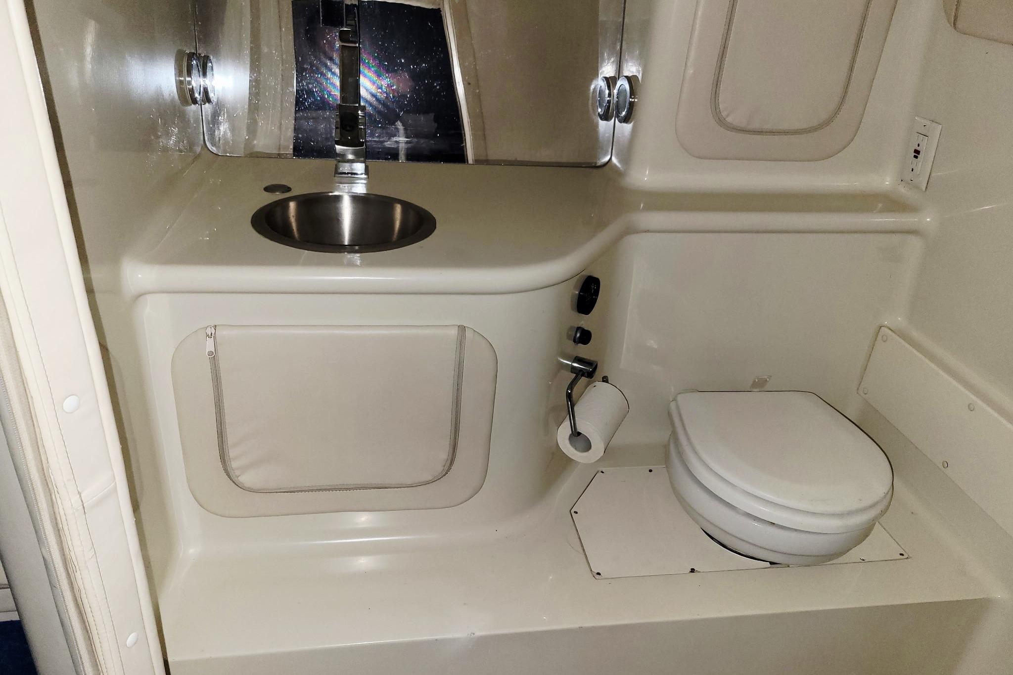 2004 Outerlimits 42 Legacy boat bathroom with sink and toilet.