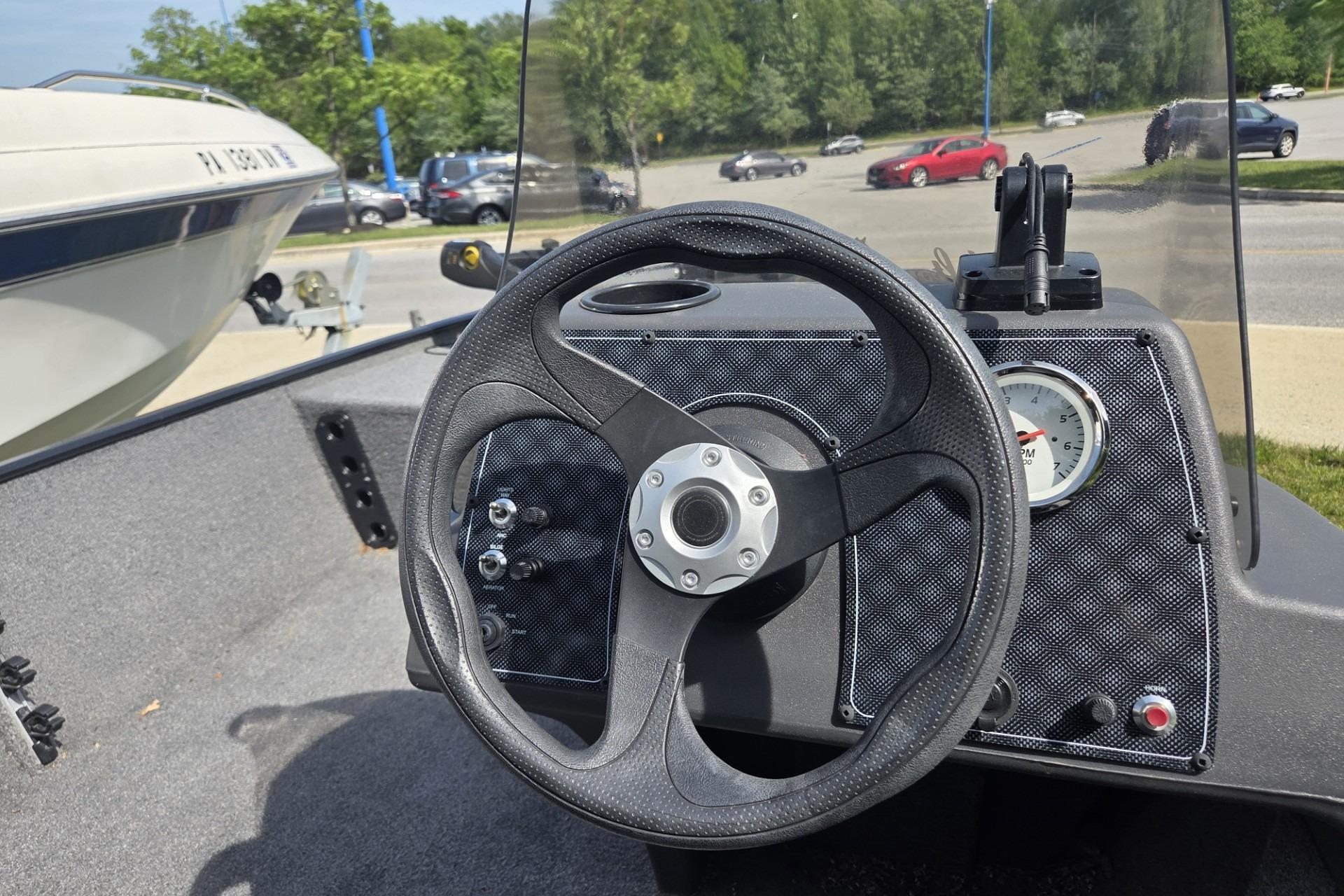 2024 TRACKER MARINE CLASSIC XL boat dashboard with steering wheel and gauges.